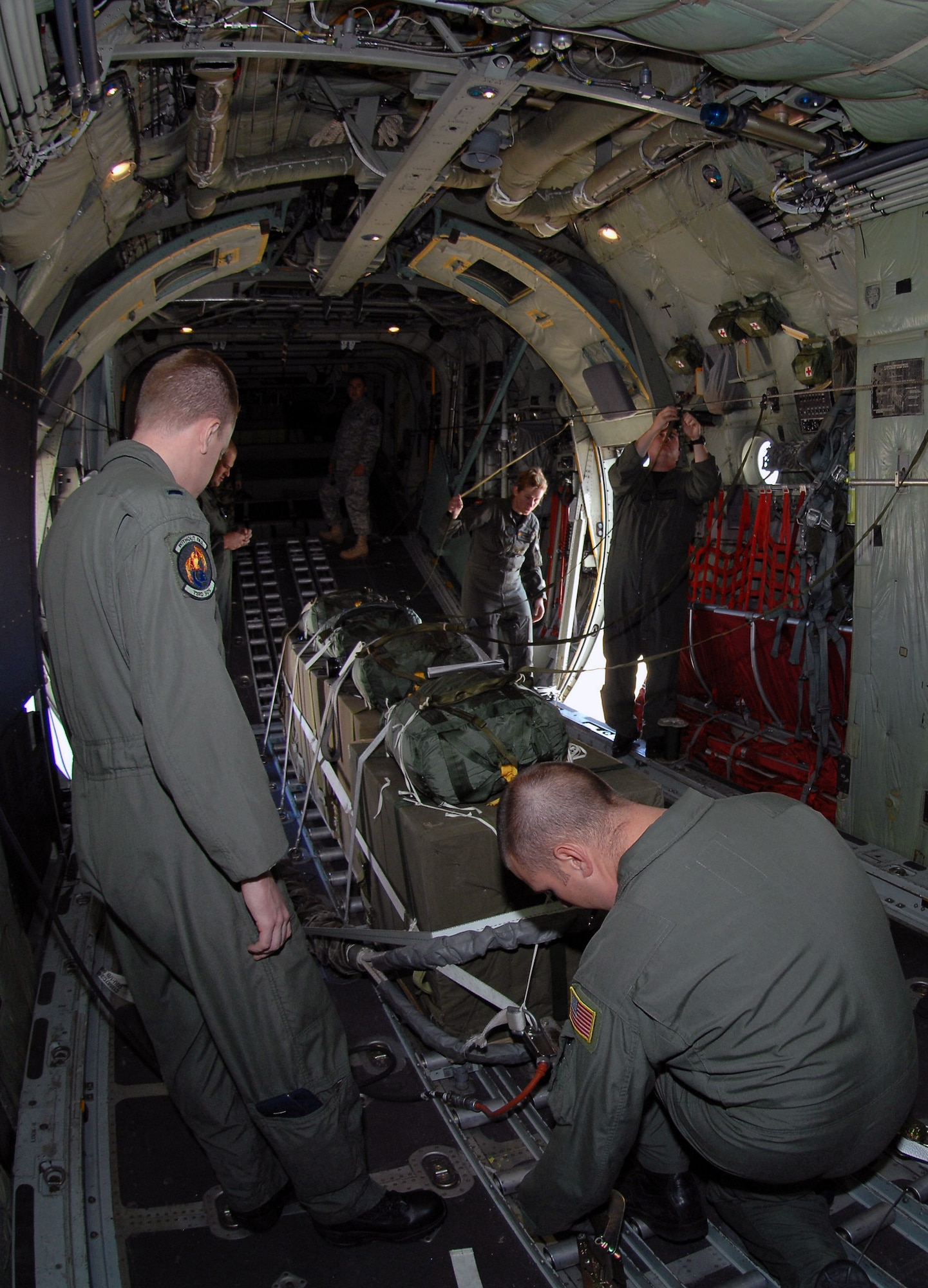 Aboard the MC-130W Combat Spear, 1st Lt. Jared Butler and Tech. Sgt. Nicholas Armitage ensure cargo is properly secured. The Airmen performed an air drop Sept. 24 as part of their regular training to get equipment to ground forces if an airfield is not available. Lieutenant Butler and Sergeant Armitage are assigned to the 73rd Special Operations Squadron. (U.S. Air Force photo/Airman Maynelinne De La Cruz)