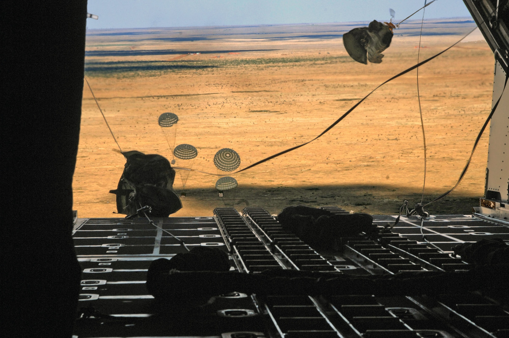 CANNON AIR FORCE BASE N.M.-- Given the green light, loadmasters from the 73rd Special Operations Squadron drop the load over Melrose Air Force Range Sept. 24 aboard the MC-130W Combat Spear aircraft. Flying low and fast enables them to get out of the area quickly and the equipment to ground personnel just as fast. (U.S. Air Force photo by Airman Maynelinne De La Cruz)
