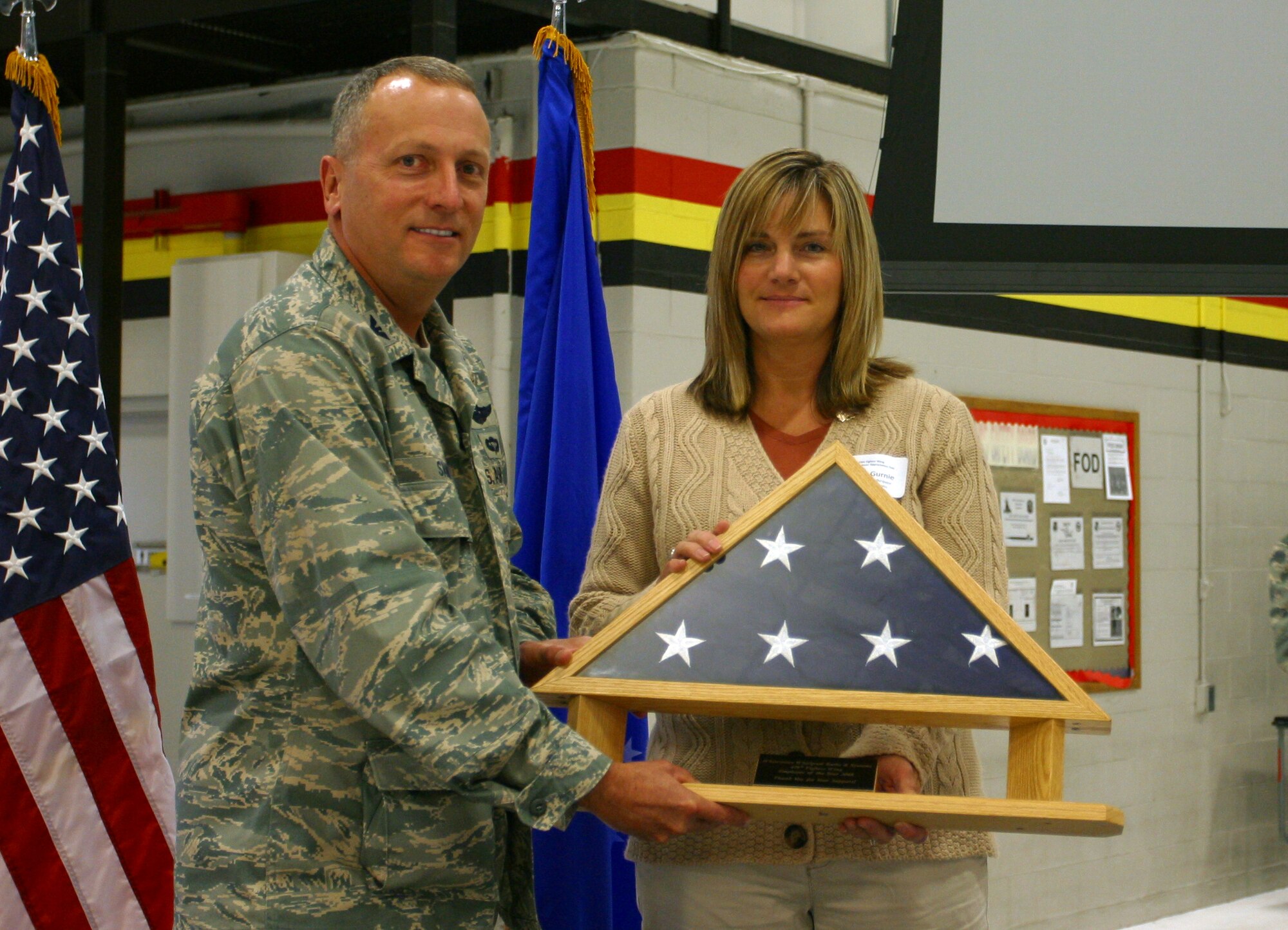 Col. Walter Sams, 419th Fighter Wing commander, presents the wing’s Employer of the Year award to Ms. Shelly Gurnie of Whitewater Whirlpool Baths and Systems.  Whitewater Whirlpool Baths and Systems of Lindon, Utah, received the award for their outstanding support of Senior Airman Chad Rasmusen, a traditional reservist with the 419th Maintenance Squadron, who deployed to Iraq for 45 days earlier this year. (U.S. Air Force photo/Staff Sgt. Kyle Brasier)