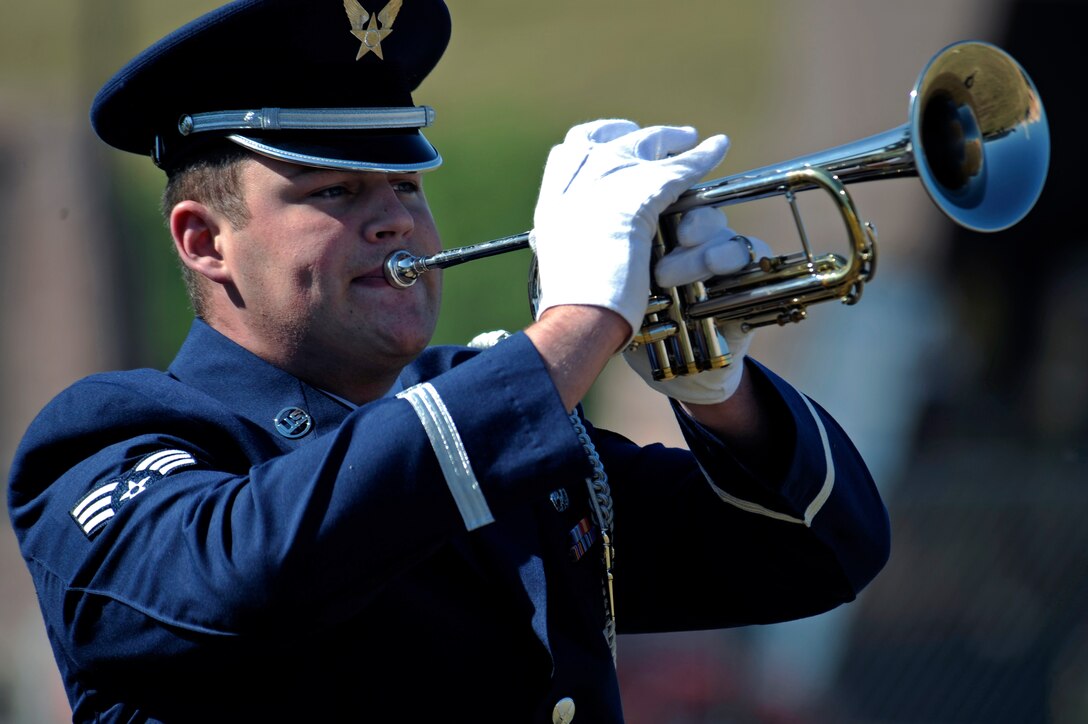 Senior Airman Kyle Hill, Ellsworth Honor Guard member plays taps at the South Dakota Air and Space Museum, Oct. 3. The names of 31 Airmen who were casualties of the airlift were announced preceding a three-gun salute and the playing of taps. (U.S. Air Force photo/Airman Matthew Flynn)