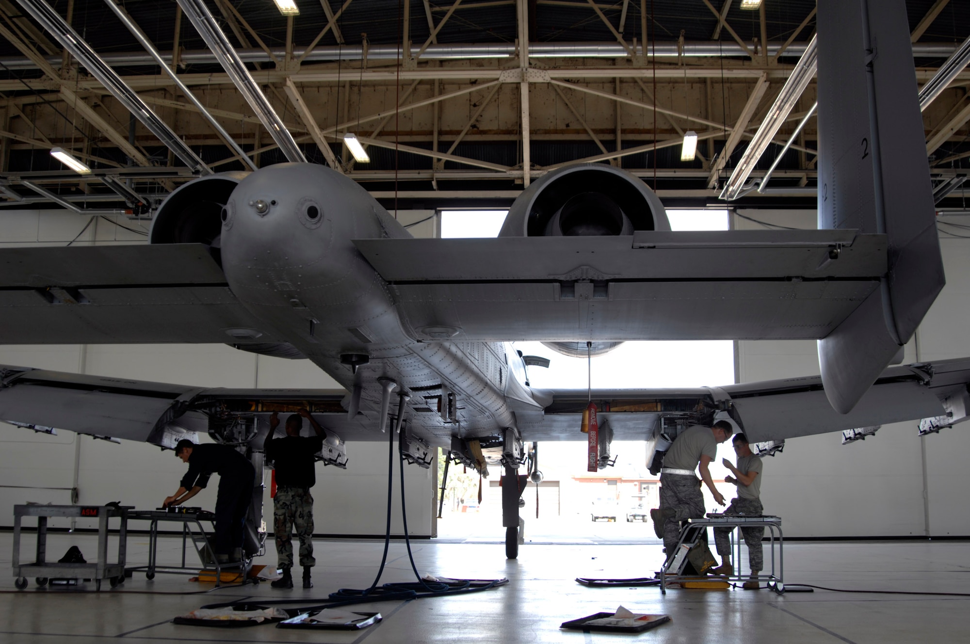 Maintainers at Moody Air Force Base, Ga., prepare to inspect an A-10 Thunderbolt II for wing frame cracks Oct. 4.  A Time Compliance Technical Order was issued by Air Force Materiel Command officials identifying certain A-10s that needed to be inspected.  The Airmen are assigned to the 23rd Equipment Maintenance Squadron.  (U.S. Air Force photo/Senior Airman Javier Cruz) 