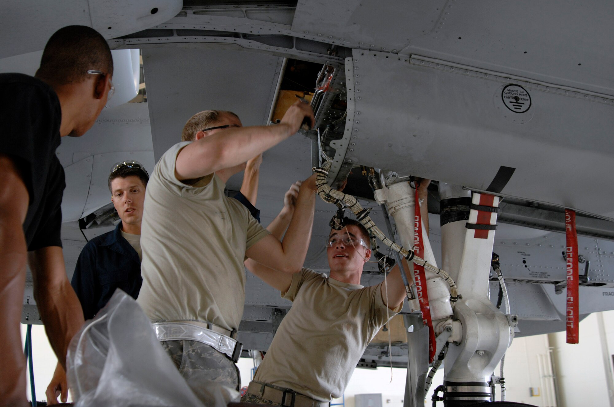 Maintainers at Moody Air Force Base, Ga., prepare to inspect an A-10 Thunderbolt II for wing frame cracks Oct. 4.  A Time Compliance Technical Order was issued by Air Force Materiel Command officials identifying certain A-10s that needed to be inspected.  The Airmen are assigned to the 23rd Equipment Maintenance Squadron.  (U.S. Air Force photo/Senior Airman Javier Cruz) 