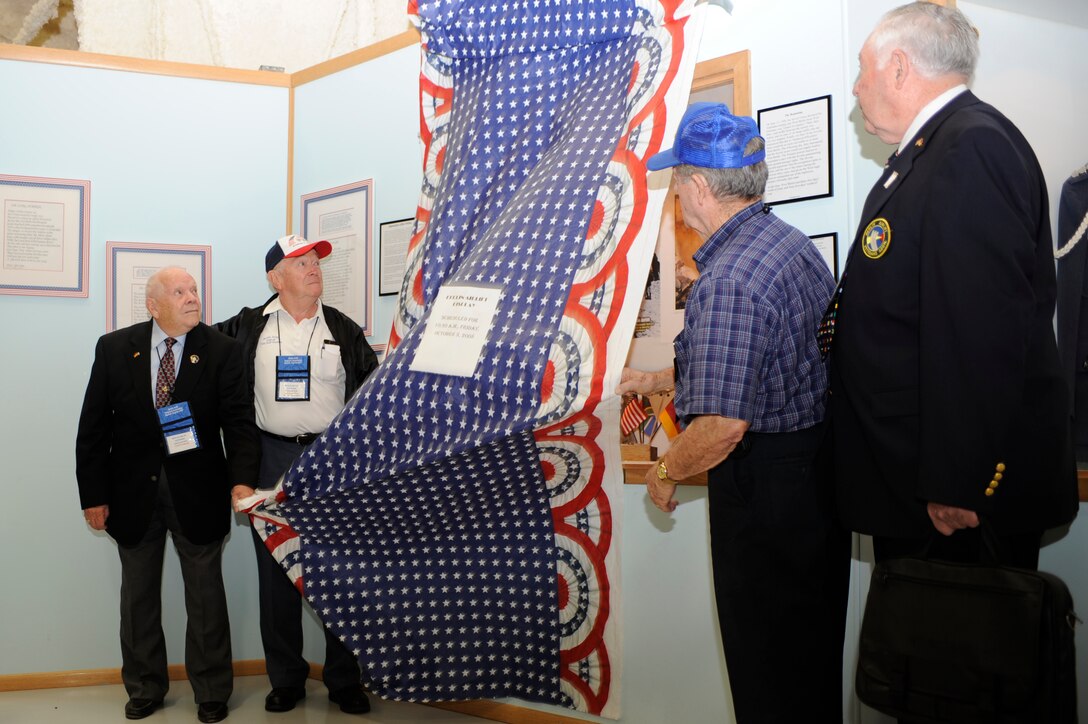 Members of the Berlin Airlift Veterans Association unveil a memorial inside the South Dakota Air and Space Museum, Oct. 3. Two memorials were unveiled at the museum to commemorate the Berlin Airlift's 60th anniversary. (U.S. Air Force photo/Airman Matthew Flynn)
