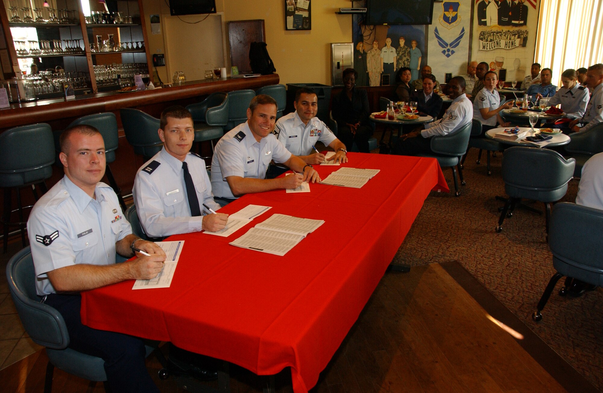 From left: Airman 1st Class Benjamin Ekblad, 71st Flying Training Wing command post, Capt. Kris Ostrowski, wing Combined Federal Campaign project officer, Col. Mark C. Nowland, 71st FTW commander, and Chief Master Sgt. Ruben Gonzalez, 71st FTW command chief, sign their CFC forms at the wing CFC kick-off luncheon at the Vance Collocated Club Oct. 6. (U.S. Air Force photo by Staff Sgt. Brian Hill)            