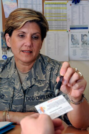 Ms. Barbara Lang explains to Staff Sgt. Christopher Doyle, firefighter assigned to the 379th Expeditionary Civil Engineer Squadron, how to use the Bright Score card to get a free credit report and score Sept. 22 at an undisclosed air base in Southwest Asia. Ms. Lang and the other Airmen Readiness Center members work in the only Airmen Readiness Center in the entire area of responsibility. Ms. Lang is the director of Airmen Readiness Center and is assigned to the 379th Expeditionary Force Support Squadron. (U.S. Air Force photo/Staff Sgt. Darnell T. Cannady)