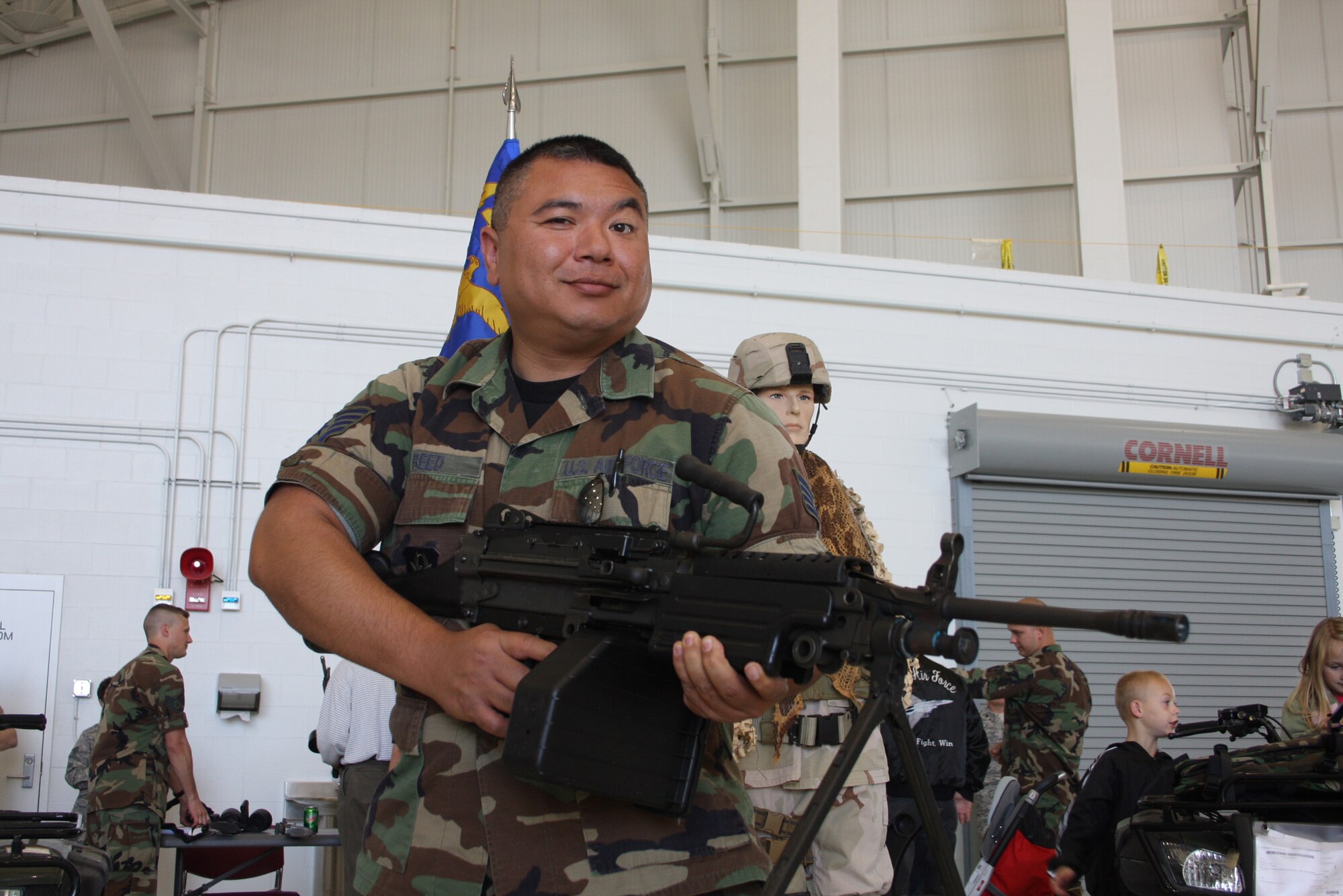 WRIGHT-PATTERSON AFB, Ohio - Staff Sgt. Thomas Reed, 445th Aircraft Maintenance Squadron, enjoys a weapons display during the 445th Airlift Wing's annual picnic Oct. 5, 2008.  The picnic was open to all wing members, their families and friends and was sponsored by the Chiefs Group. (Air Force photo/Senior Airman Ken LaRock)