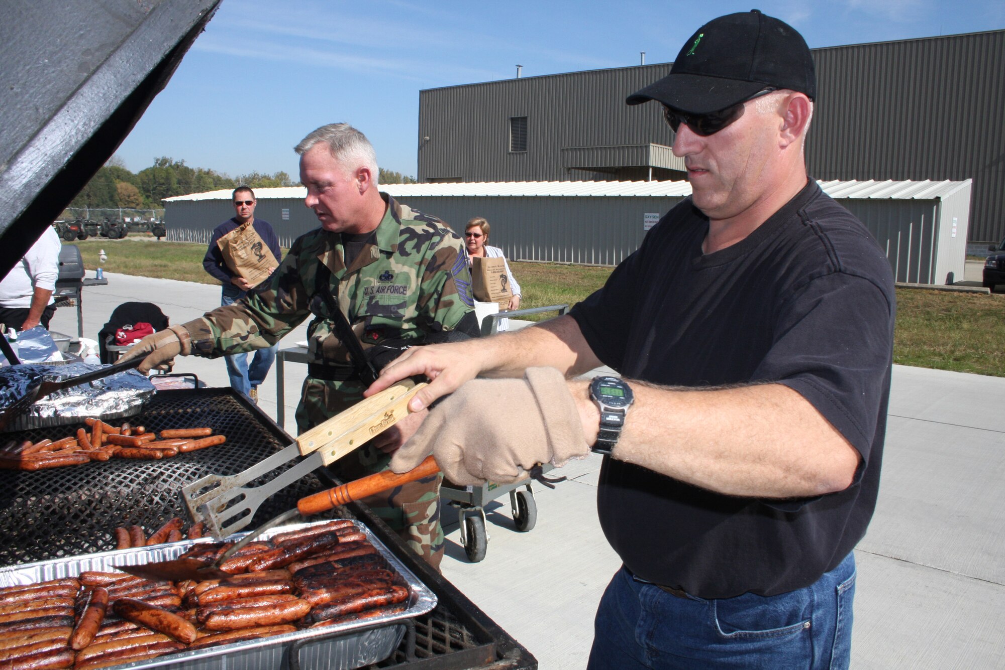WRIGHT-PATTERSON AFB, Ohio - Tech. Sgt. Mike Heaton, 445th Aircraft Maintenance Squadron, and Chief Stephen Drain, 445th Maintenance Group, work at the grill during the 445th Airlift Wing's annual picnic Oct. 5, 2008.  The picnic was open to all wing members, their families and friends and was sponsored by the Chiefs Group. (Air Force photo/Senior Airman Ken LaRock)