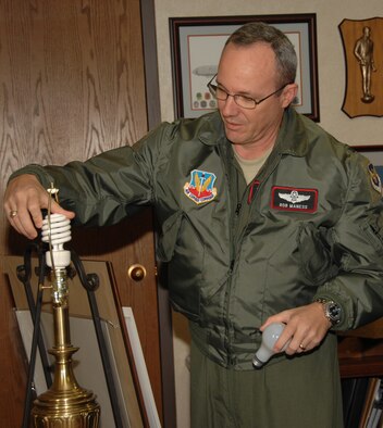 OFFUTT AIR FORCE BASE, Neb. -- Col. Robert Maness, 55th Wing vice commander, replaces a standard incandescent bulb in his office with an Energy Star qualified compact fluorescent lamp as part of the Department of Defense campaign “Operation Change Out.” The campaign challenges military bases across the country to install CFLs in their facilities as part of Energy Conservation Month in October. 
“Our engineers and our environmental folks are constantly looking at our facilities to see ways we can save energy,” said Colonel Maness. The 55th Wing is currently working on putting meters on many buildings on base so energy usage can be measured by building, he said, furthering Offutt’s capability to conserve energy. (U.S. Air Force Photo By Kendra Williams)
