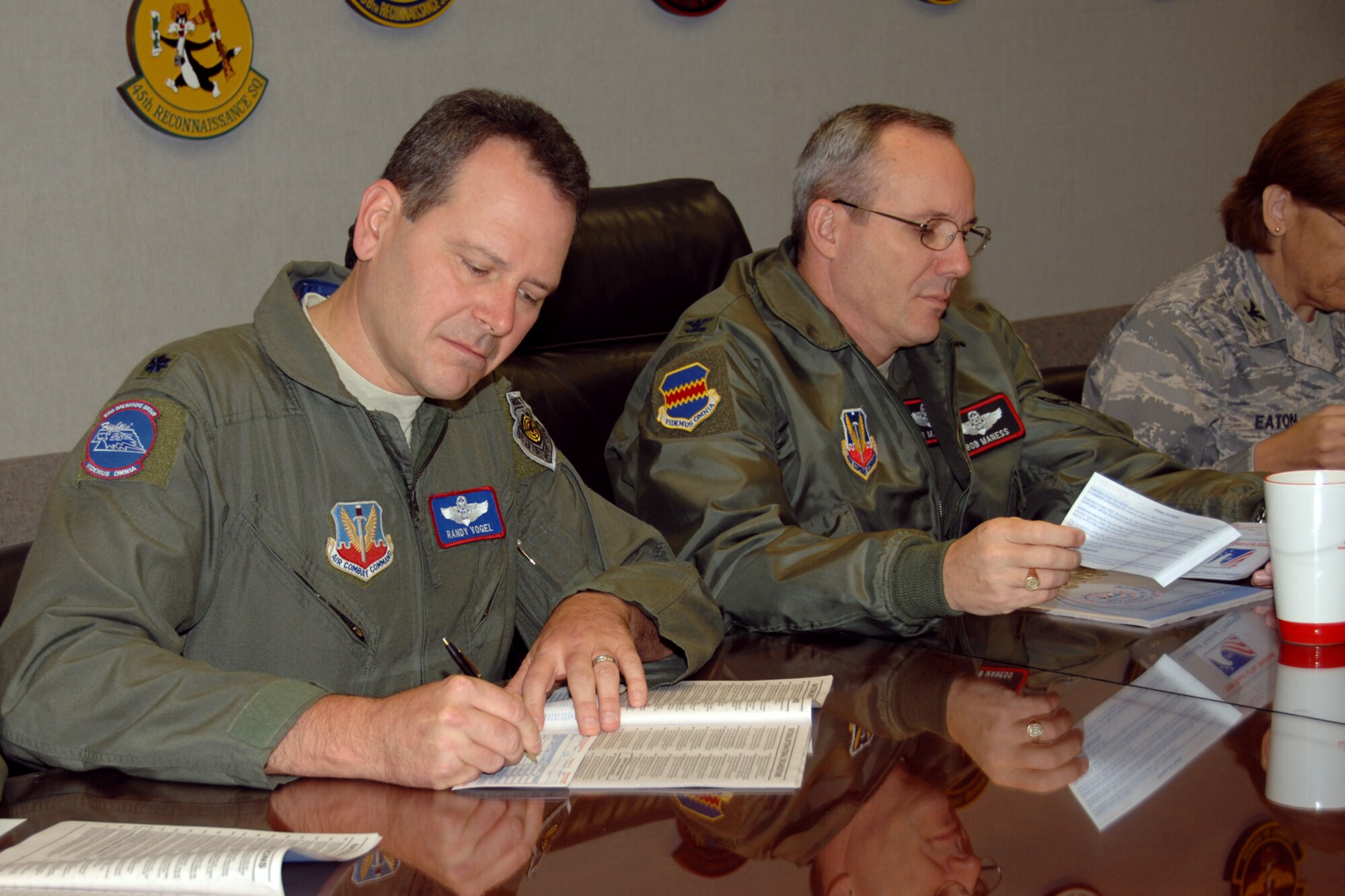 (Left to right) Lt. Col. Randall Vogel, 55th Operations Group deputy commander, and Col. Robert Maness, 55th Wing vice commander, complete their 2008 Combined Federal Campaign pledge forms after a 55th Wing group commander’s meeting here Oct. 3.  Pledges made by federal civilian and military donors during the campaign season support eligible non–profit organizations that provide health and human service benefits throughout the world. This year’s CFC fund drive runs through Dec. 15. People who would like to contribute to the CFC should ask their unit representatives for more information. (U.S. Air Force Photo By Kendra Williams)