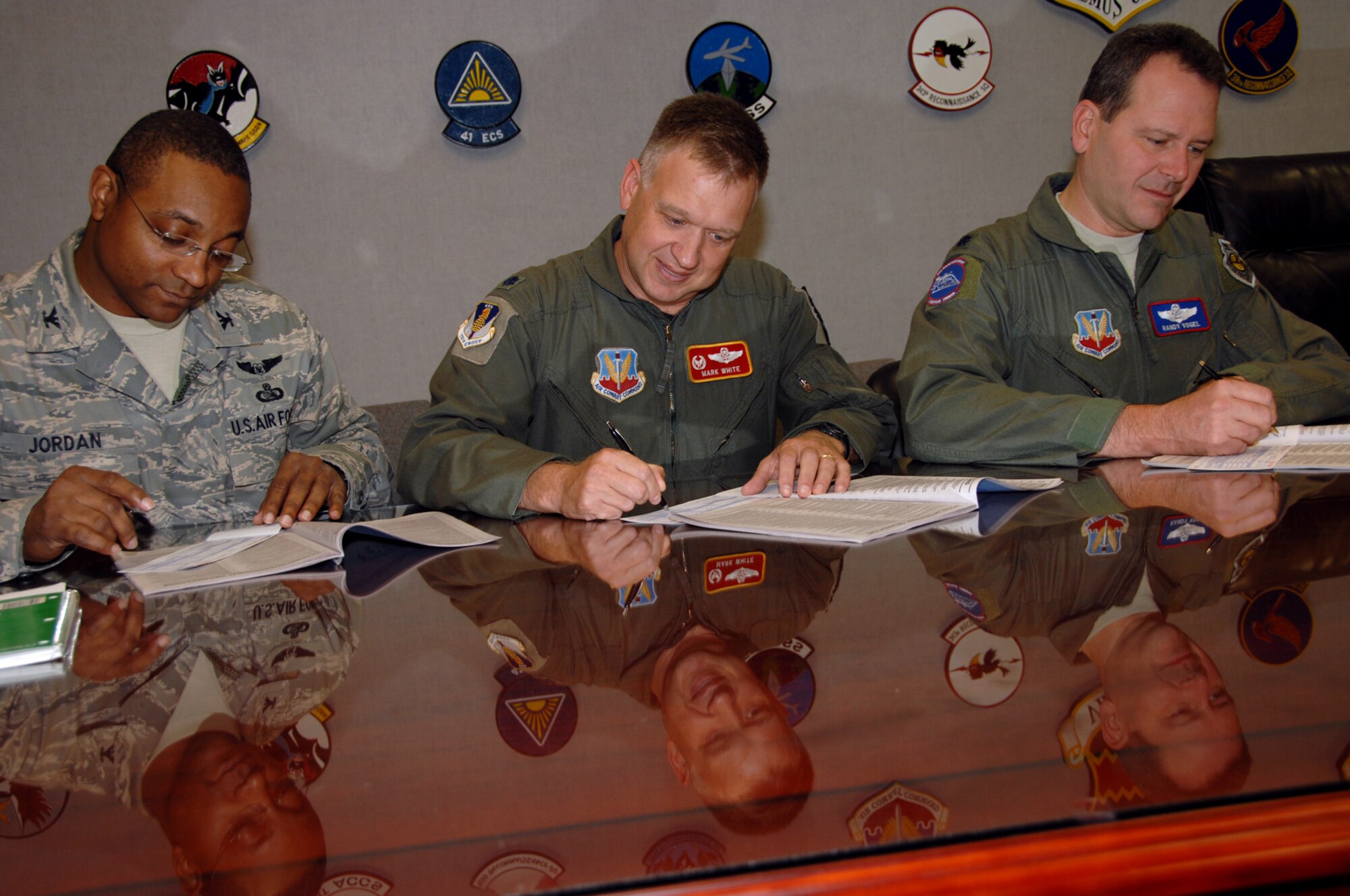 (Left to right) Col. Boykin B. Jordan Jr., 55th Communications Group commander; Lt. Col. Mark White, 170th Group commander and Lt. Col. Randall Vogel,  55th Operations Group deputy commander complete their 2008 Combined Federal Campaign pledge forms after a 55th Wing group commander’s meeting here Oct. 3.  Pledges made by federal civilian and military donors during the campaign season support eligible non–profit organizations that provide health and human service benefits throughout the world. This year’s CFC fund drive runs through Dec. 15. People who would like to contribute to the CFC should ask their unit representatives for more information. (U.S. Air Force Photo By Kendra Williams)