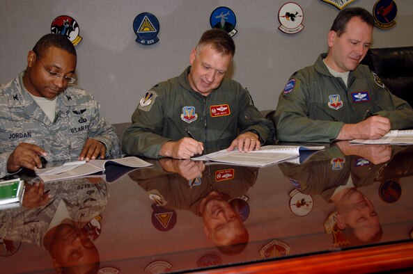 (Left to right) Col. Boykin B. Jordan Jr., 55th Communications Group commander; Lt. Col. Mark White, 170th Group commander and Lt. Col. Randall Vogel,  55th Operations Group deputy commander complete their 2008 Combined Federal Campaign pledge forms after a 55th Wing group commander’s meeting here Oct. 3.  Pledges made by federal civilian and military donors during the campaign season support eligible non–profit organizations that provide health and human service benefits throughout the world. This year’s CFC fund drive runs through Dec. 15. People who would like to contribute to the CFC should ask their unit representatives for more information. (U.S. Air Force Photo By Kendra Williams)