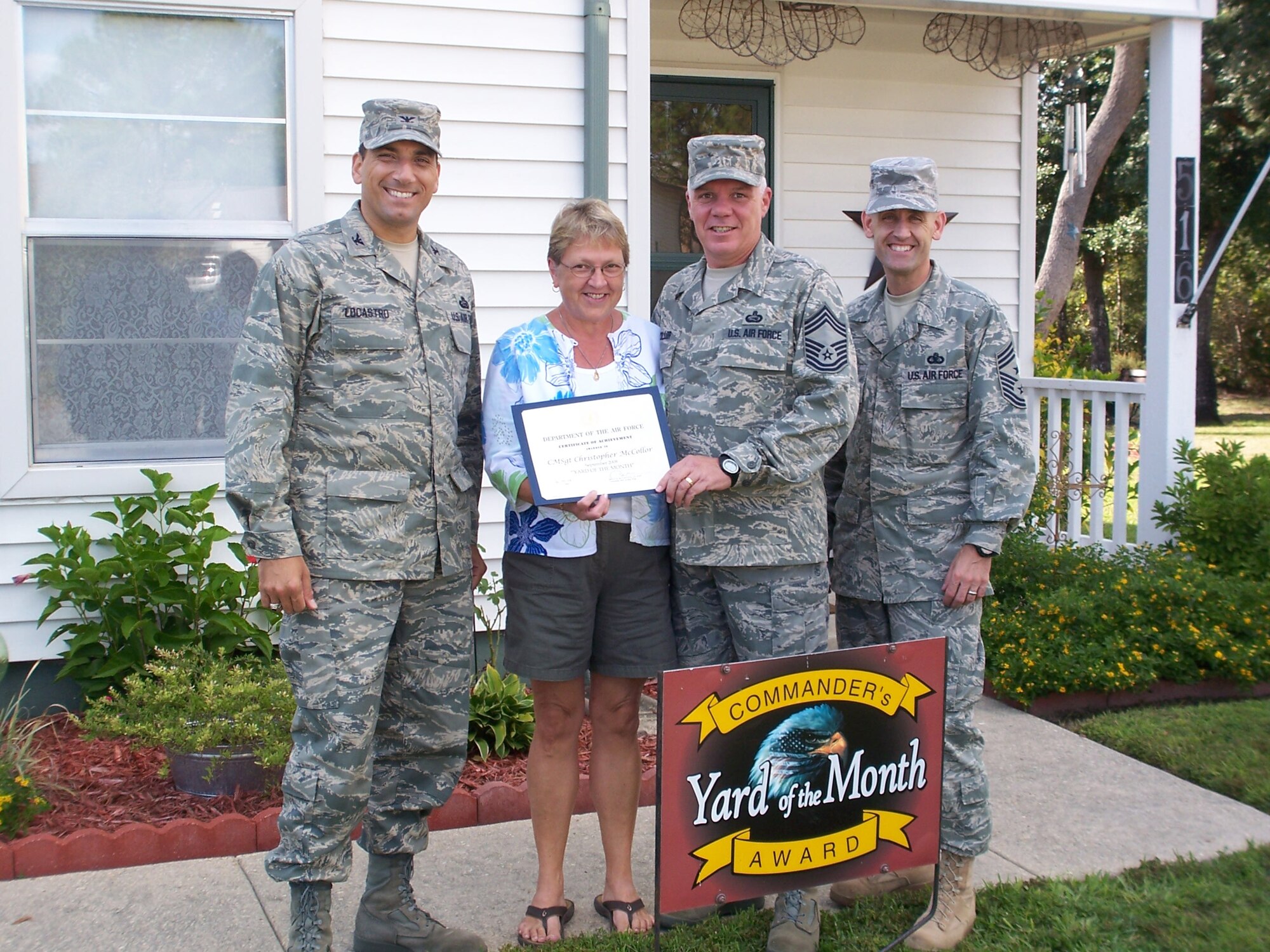 Col. Rick LoCastro, 96th Air Base Wing vice commander, presents Chief Master Sgt. Christopher McColler 96 Mission Support Group and his wife Nancey with a certificate of award in the Yard of the Month competition. Command Chief Master Sgt. Troy Engholm was also present. The McCollers also received two $25 gift cards. (USAF photo by Timothy Crews) 