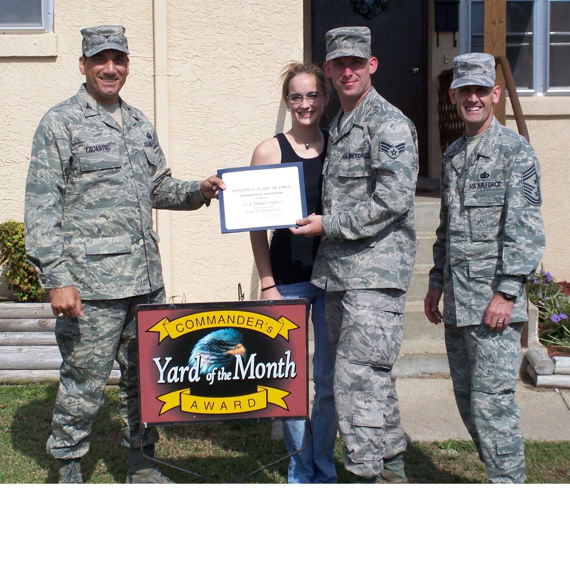 Col. Rick LoCastro, 96th Air Base Wing vice commander, presents SeniorAirman  Daniel Eckert, 46th Aircraft Maintenance Squadron and his wife Lindsey with a certificate of award in the Yard of the Month competition. Command Chief Master Sgt. Troy Engholm was also present. The Eckerts also received two $25 gift cards. (USAF photo by Timothy Crews) 