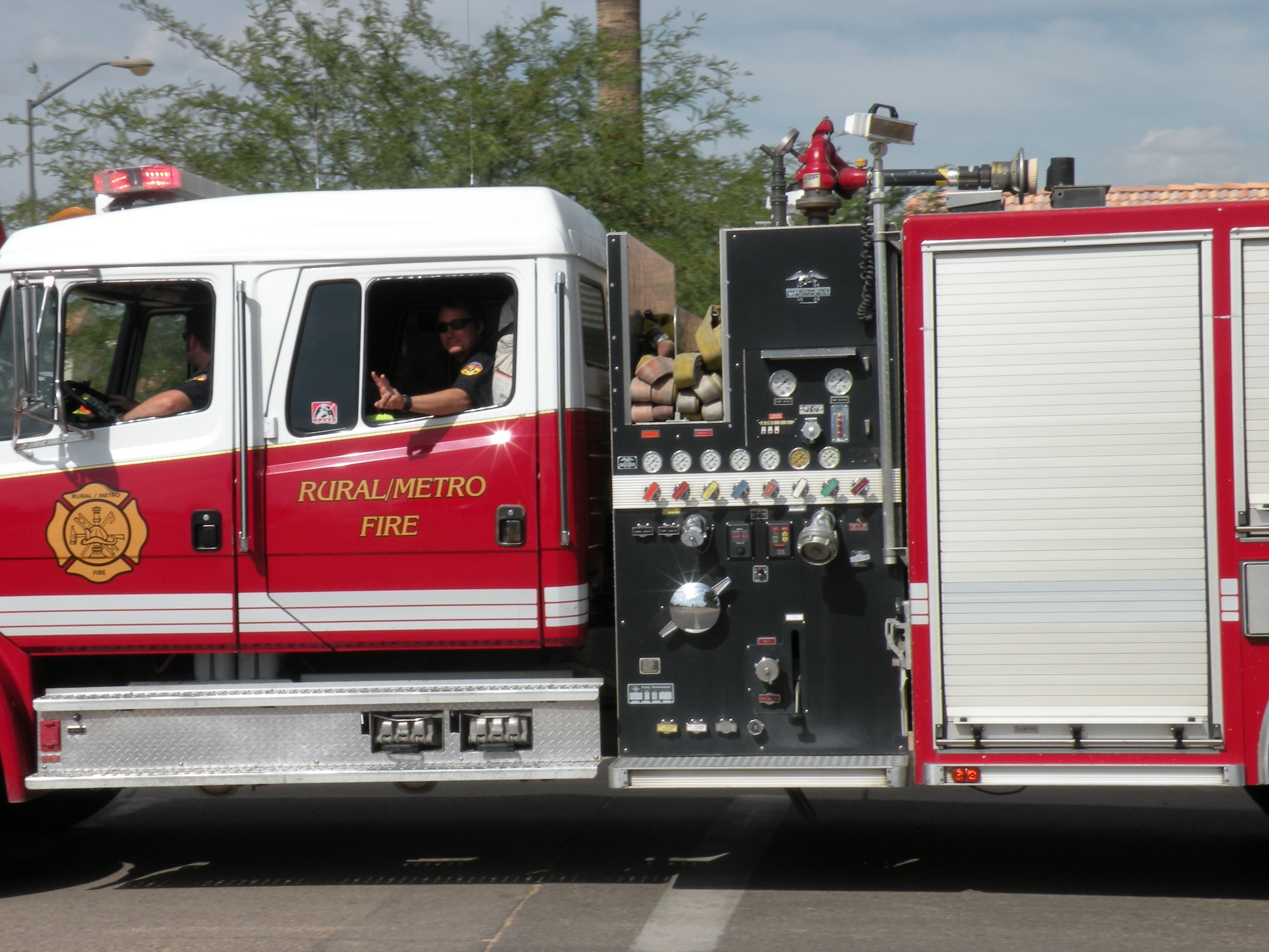 A fireman flashes the peace sign during the Fire Prevention Week Parade here Oct. 4, which featured a variety of different style fire trucks. The parade kicked off the Annual National Fire Prevention Week Campaign. (U.S. Air Force photo by Master Sgt. Angela Thorbs)   