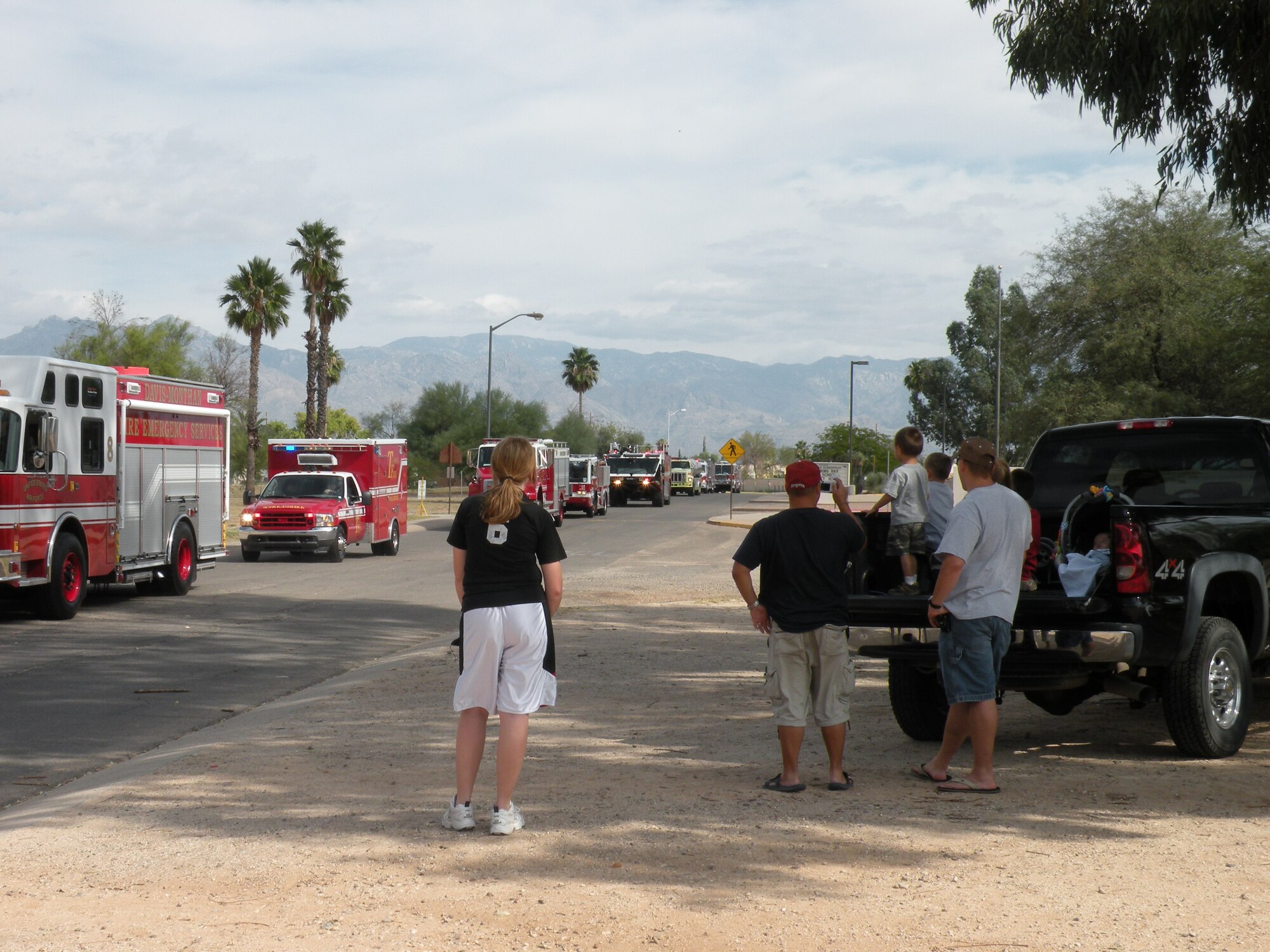 Families watch the Fire Prevention Week Parade, featuring a variety of different style fire trucks here Oct. 4. The parade kicked off the Annual National Fire Prevention Week Campaign. (U.S. Air Force photo by Master Sgt. Angela Thorbs)                               