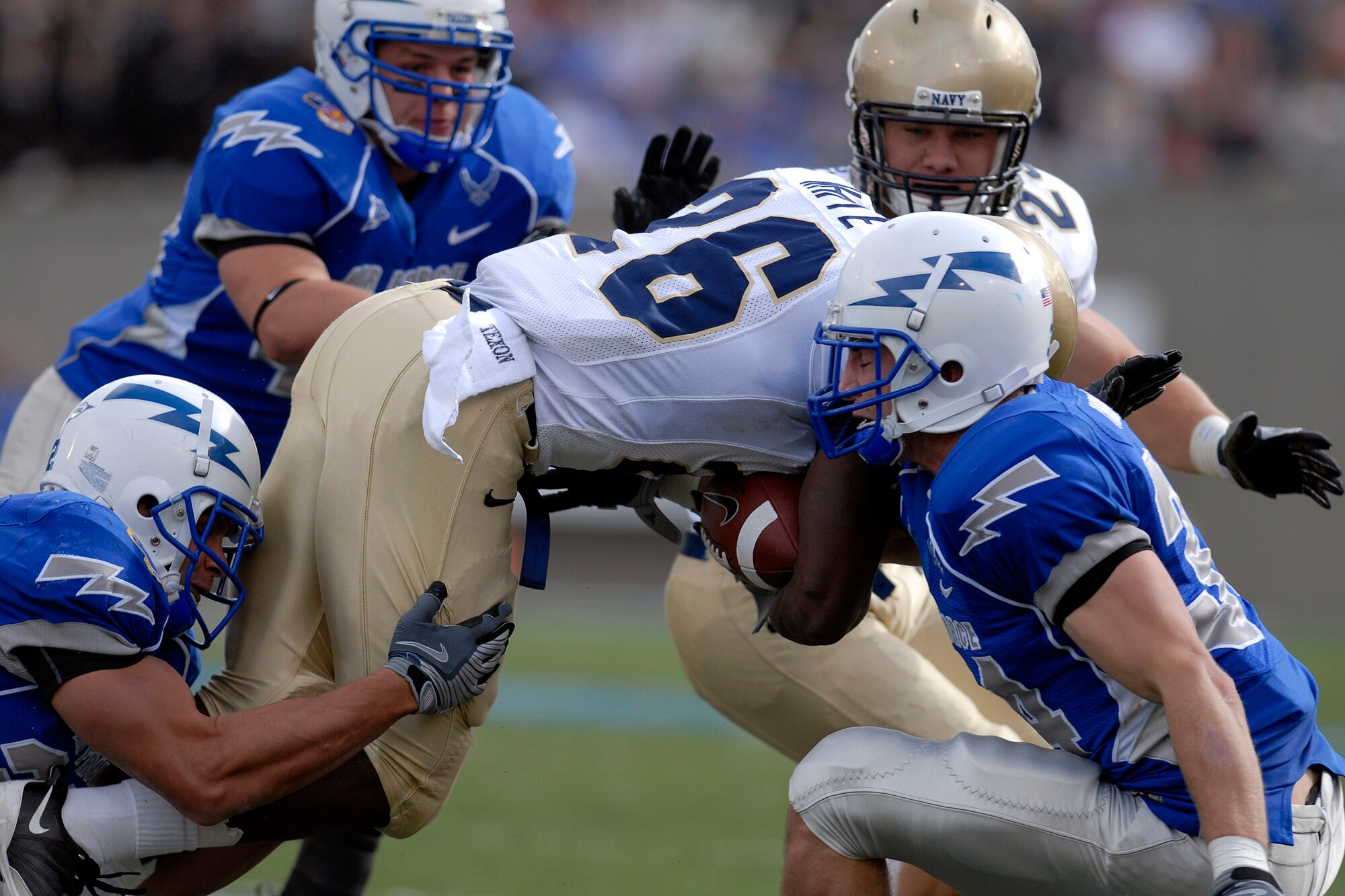 U.S. Air Force Academy safety Chris Thomas strips the ball as Navy defeated the Falcons 33-27 at the Academy in Colorado Oct. 4. (U.S. Air Force photo/Mike Kaplan) 
