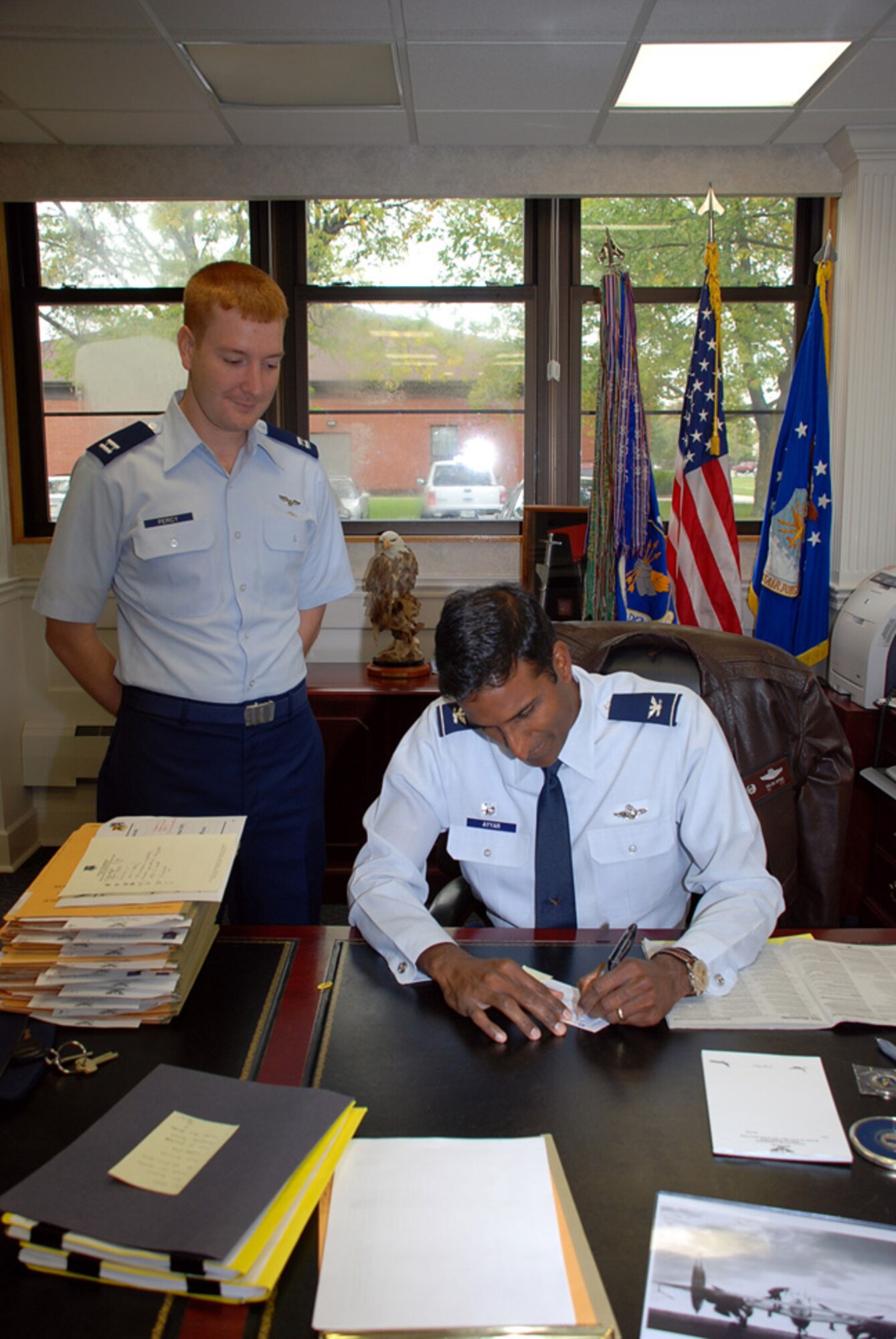 Right, Col. Balan Ayyar, 305th Air Mobility Wing commander, fills out his Combined Federal Campaign donation form Oct. 6. The campaign, which runs through Nov. 21, benefits more than 2,000 local, national and international charities. For more information, call Capt. Chris Percy, left, 305th AMW CFC representative, at (609) 754-3567. (U.S. Air Force photo/Airman 1st Class Bekah Phy) 
