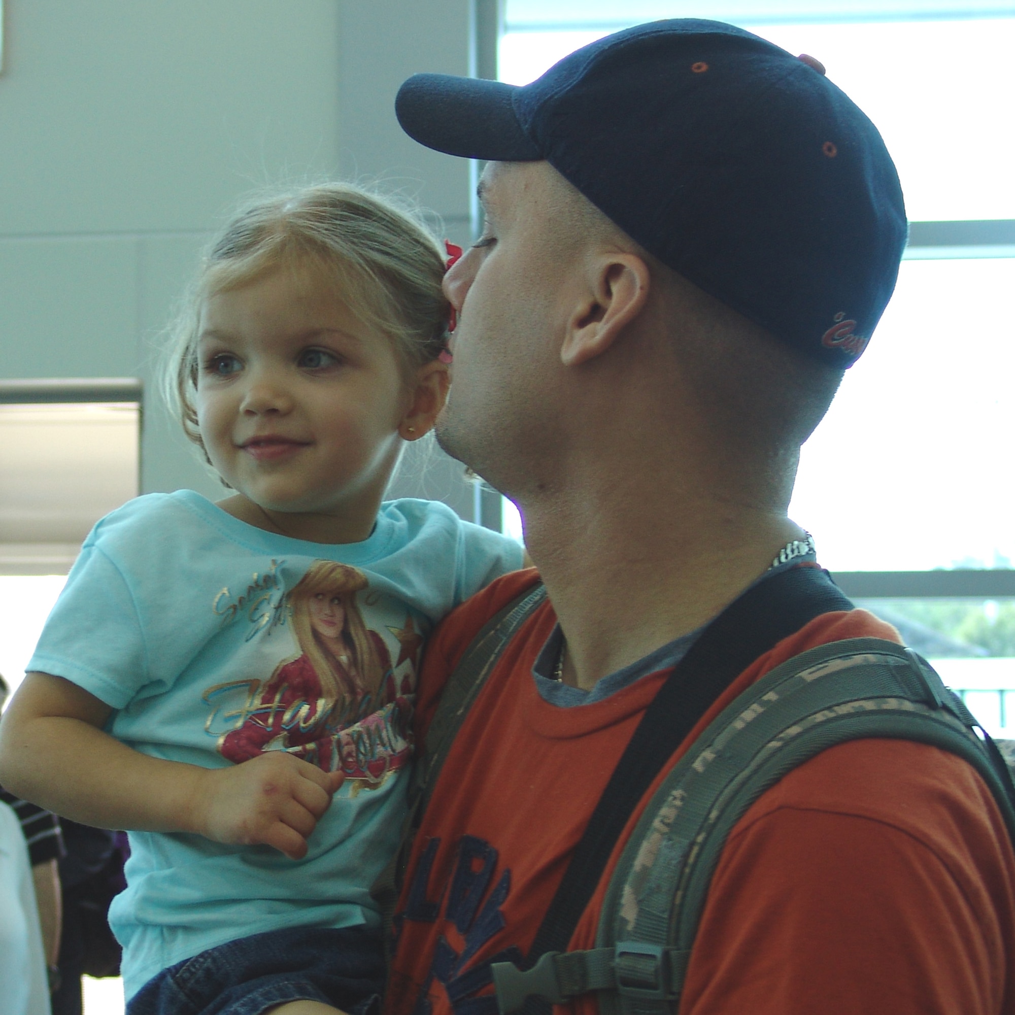 Noel Zuber welcomes her daddy, Senior Airman David Zuber, home from deployment.  The Airman was deployed with a 96th Security Forces Squadron team for six months. (USAF photo by Lois Walsh)