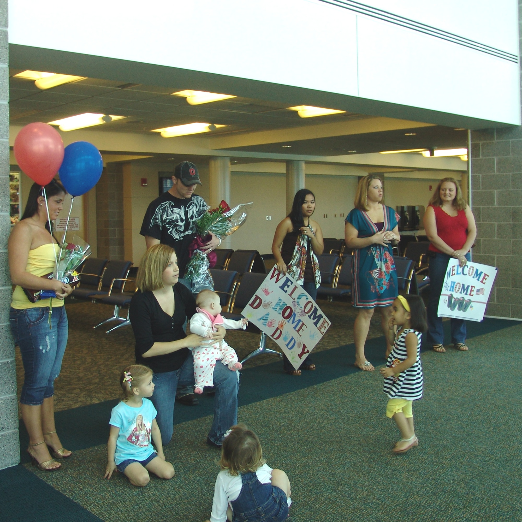 Spouses wait patiently for deployed Airmen to return home Oct. 5. A 96th Security Forces team arrived after being deployed for six months. (USAF photo by Lois Walsh)                         