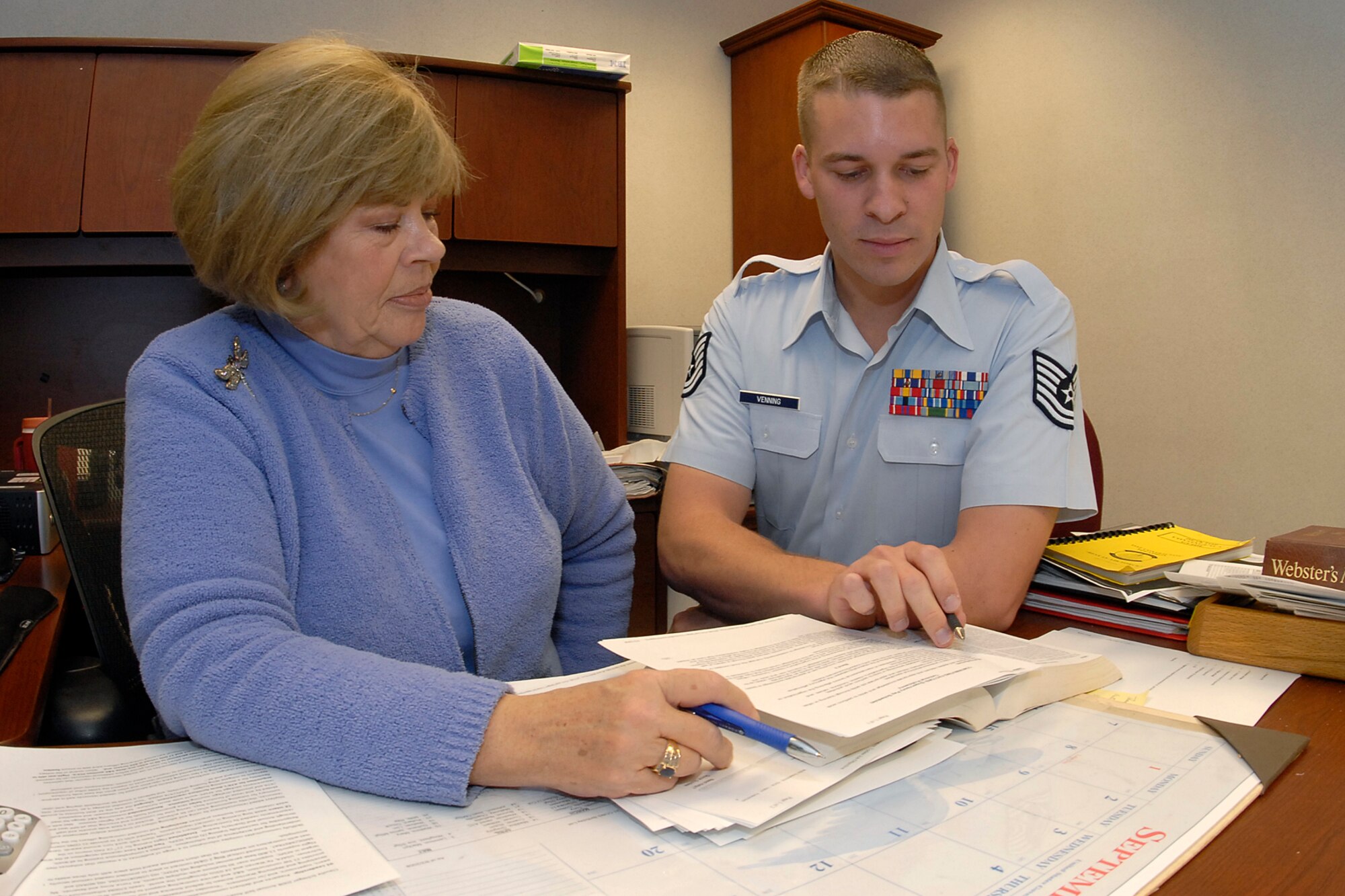 Tech. Sgt. Michael Venning and Ms. Claudia Schlegel, 21st Contracting Squadron Infrastructure Flight, confer with one another over a contracting concern. To better serve customers going into the new fiscal year, the 21st CONS has put together some tips and other helpful information that will make your experience with contracting that much easier. (U.S. Air Force photo/Rob Bussard)