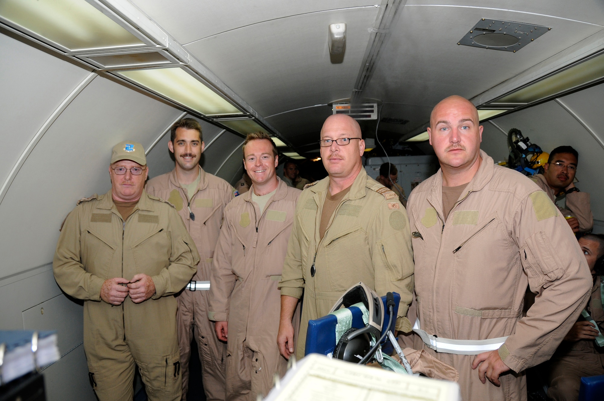 SOUTHWEST ASIA -- Members of the 965th Expeditionary Airborne Air Control Squadron pose for a quick group photo before going on a mission in support of the global war on terrorism here Oct. 4. The personnel shown are from Canada, Australia and the United Kingdom. This is an exchange program allowing coalition forces to learn from each other both in their respective countries and in a deployed operational environment. This unit is currently deployed from Tinker Air Force Base, Okla. (U.S. Air Force photo/Tech. Sgt. Christopher A. Campbell)(released)