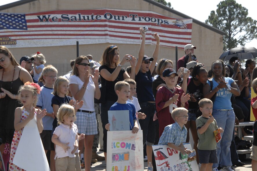 MOODY AIR FORCE BASE, Ga., -- Airmen of the 822nd Security Forces Squadron return from a six-month deployment in Iraq here Oct. 4. Many of the Airmen were anxious to reunite with family members awaiting their arrival. Family and friends of the 822nd SFS gathered at a staging point to greet the airmen as they marched into the area. (U.S. Air Force Photo by Senior Airman Javier Cruz)