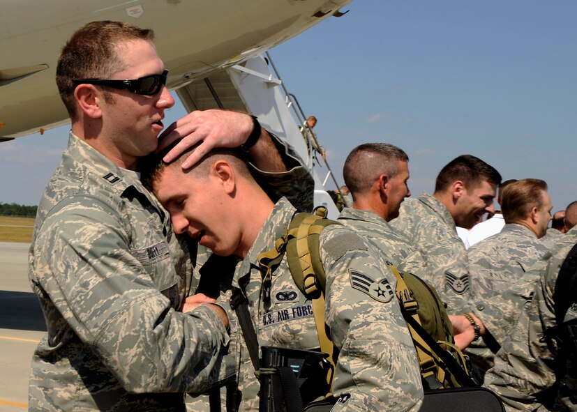 MOODY AIR FORCE BASE, Ga. -- Captain Jason Duffy hugs a member of the 822nd Security Forces Squadron after arriving here Oct. 4 from a deployment to Iraq. The 822nd Security Forces Squadron was later greeted by family members and friends during a welcome home ceremony.  (U.S. Air Force photo by Senior Airman Brittany Barker)