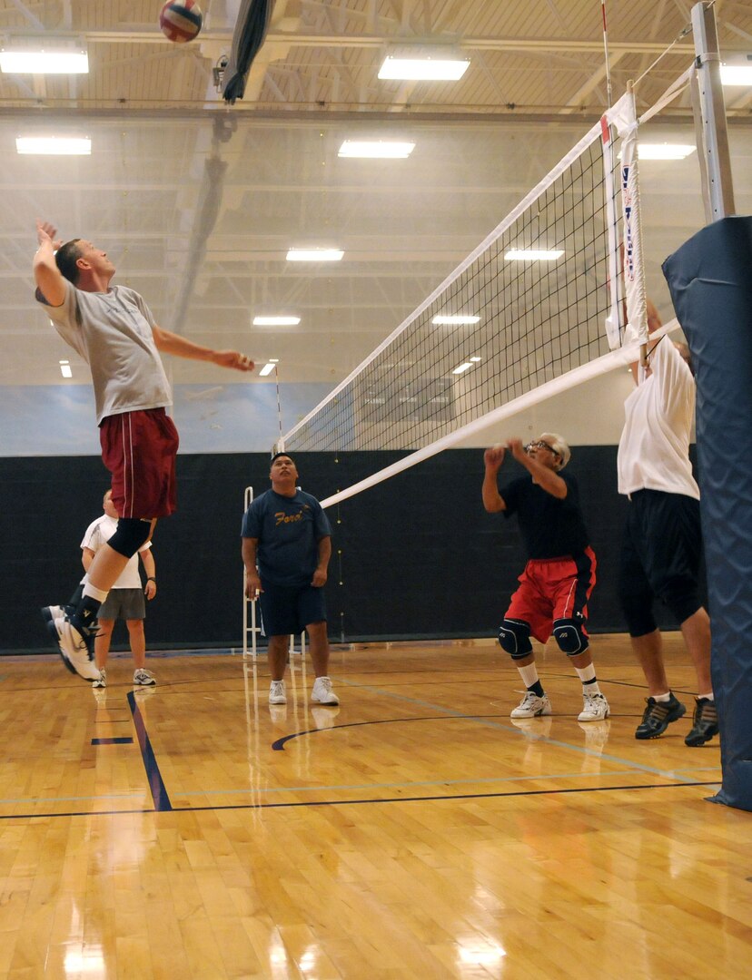 David Bailey jumps to slam the ball over the net during a lunchtime game of volleyball Sept. 30. Anyone interested in playing can join in Tuesdays and Thursdays from 11 a.m. to 1 p.m. at the fitness center. (U.S. Air Force photo by Rich McFadden)