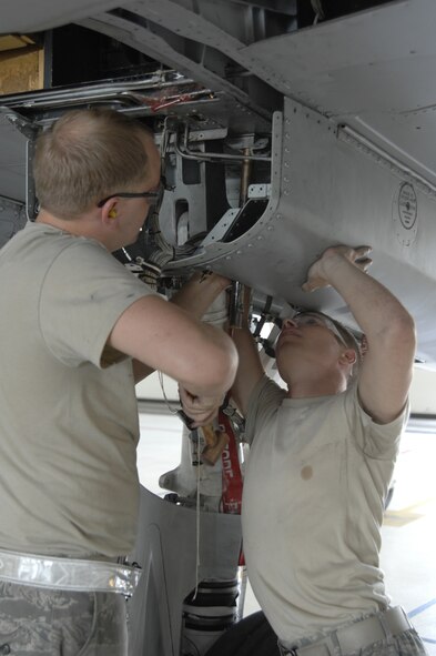 MOODY AIR FORCE BASE, Ga. --  Airman 1st Class Talmadge Borthwick (right) and Senior Airman John Grable (left), 23rd Equipment Maintenance Squadron, make preparations to inspect for cracks within the wing frame of a A-10C Thunderbolt  II model grounded here Oct. 4. After identifying structural cracks on thin skinned A-10s and A-10C Thunderbolt II models the Air Combat Command has issued a systematic grounding of certain affected airframes by corresponding tail number. The risk of structural damage to wings of A-10 models was discovered at Hill Air Force Base, UT. (U.S. Air Force Photo taken by SrA Javier Cruz)