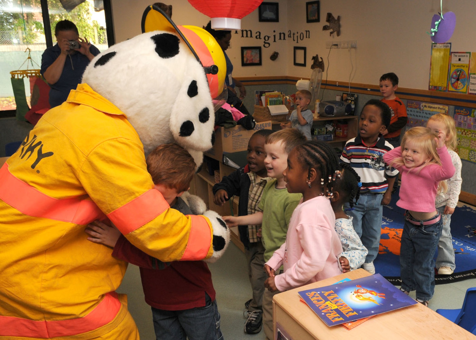Children aged 3 to 5 years old, jump up and down in excitement and run into the arms of Sparky the fire dog during his visit to the Child Development Center Oct. 6, 2008, on RAF Mildenhall, England. The visit to the CDC is in support of “Fire Prevention Week” that takes place from Oct. 5 through 11, providing servicemembers and their families helpful tips and information about fire safety. (U.S. Air Force photo by Staff Sgt. Jerry Fleshman)