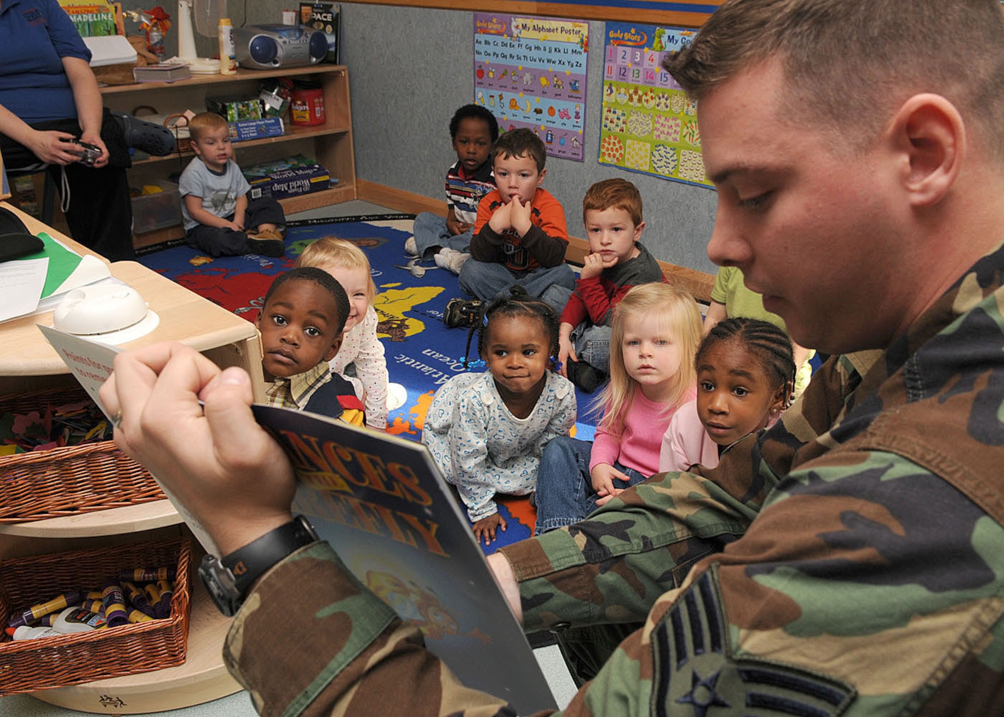 Staff Sgt. Guy Carriveau, a firefighter from the 100th Civil Engineering Squadron, reads a book to children ages 3 to 5 years old about the importance of fire safety at the Child Development Center Oct. 6, 2008, at RAF Mildenhall, England. The visit was in support of “Fire Prevention Week” that takes place from Oct. 5 through 11, providing servicemembers and their families helpful tips and information about fire safety. (U.S. Air Force photo by Staff Sgt. Jerry Fleshman)