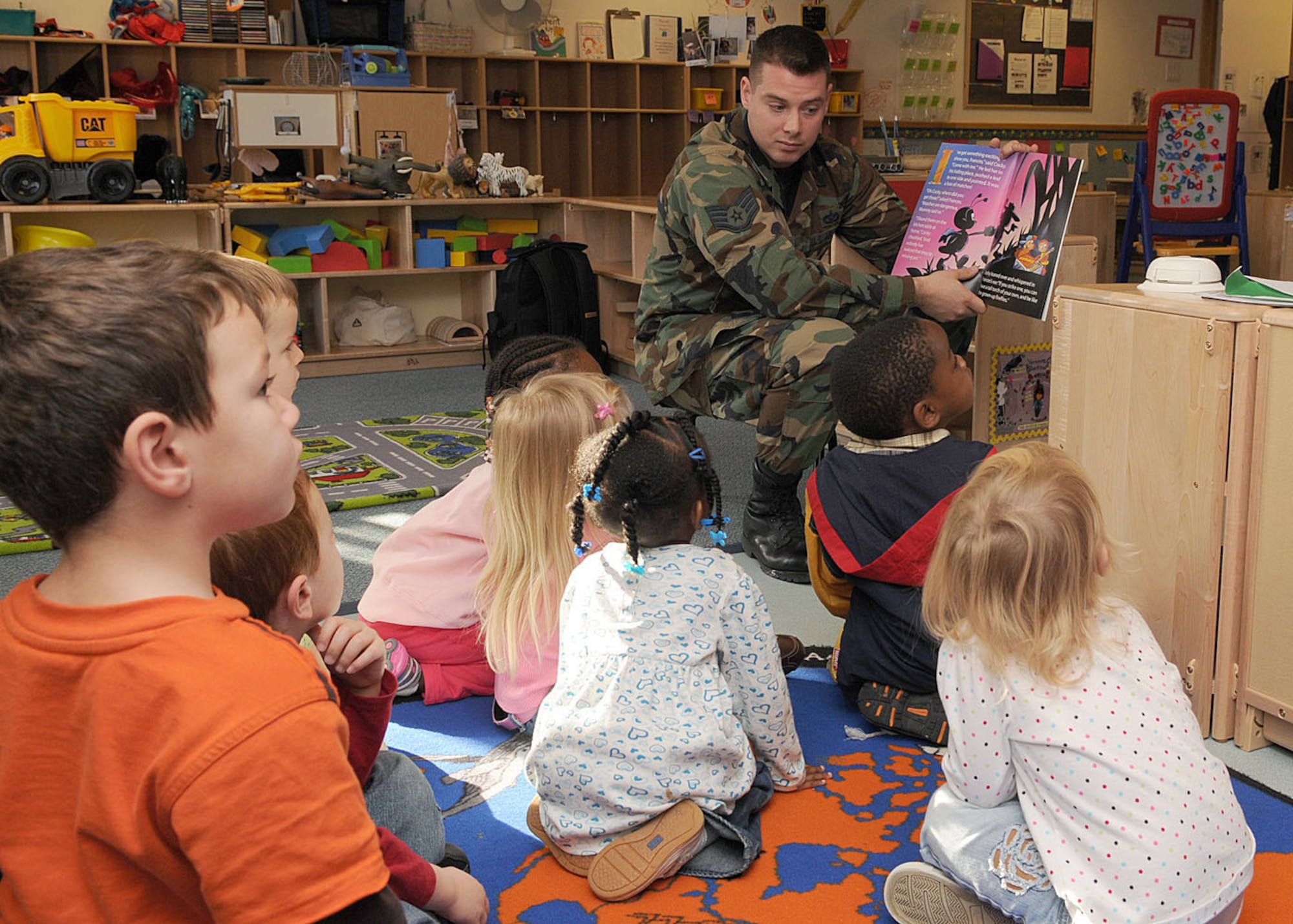 Staff Sgt. Guy Carriveau, a 100th Civil Engineer Squadron firefighter, reads a book to children ages 3 to 5 years old about the importance of fire safety during his visit to the Child Development Center Oct. 6, 2008, at RAF Mildenhall, England. The visit was in support of “Fire Prevention Week” which takes place from Oct. 5 through 11, providing servicemembers and their families helpful tips and information about fire safety. (U.S. Air Force photo by Staff Sgt. Jerry Fleshman)