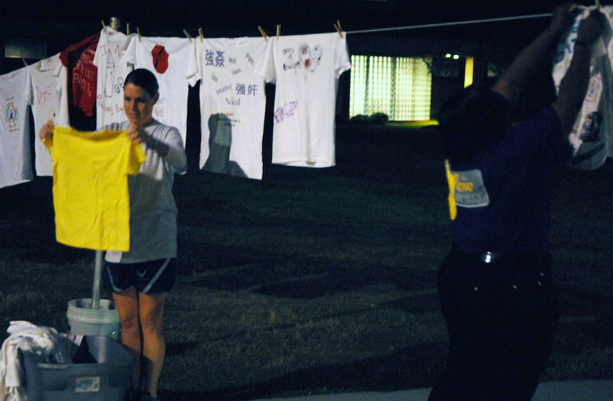 MOODY AIR FORCE BASE, Ga. – Lawanna Barron, director of the clothes line display, looks at a shirt here Oct. 3. Mrs. Barron participates in the clothes line display in support for prevention against domestic violence. (U.S. Air Force photo by Airman Joshua A. Green) 