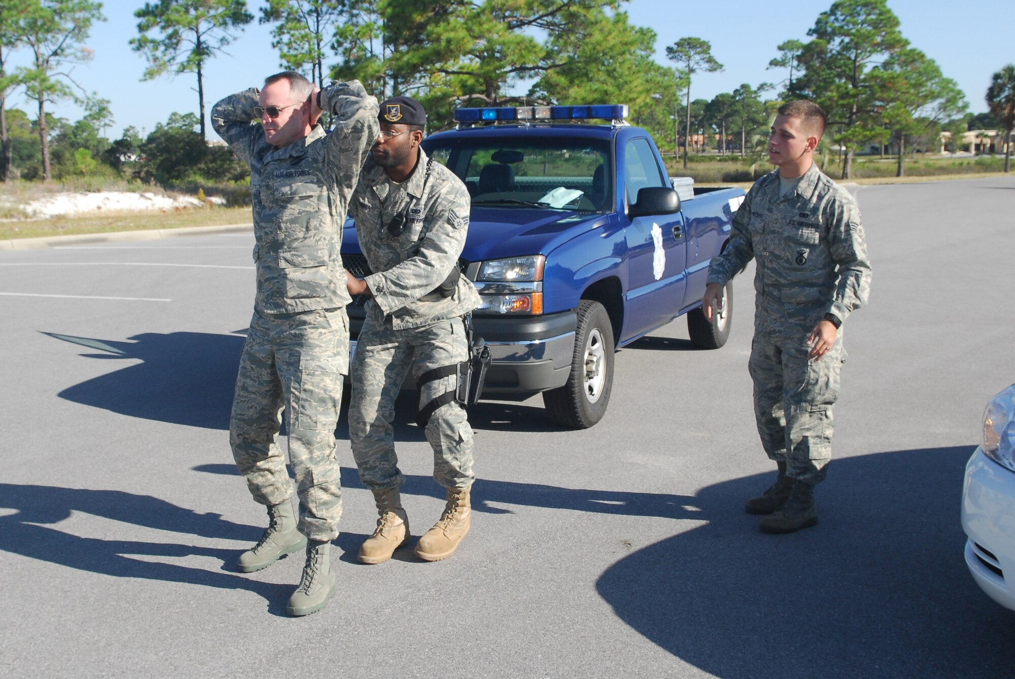 Senior Airman Steven Montiero, 325th Security Forces Squadron standardization evaluator, evaluates Senior Airman Olusola Adenuga, 325th SFS response force leader, and Brig. Gen. Darryl Roberson, 325th Fighter Wing commander, during an exercise Oct. 2 near the NCO Beach.  Airman Montiero, selected for the Commander’s Shadow Program, is responsible to security forces for preparing written, oral and performance tests, evaluating and validating certifications and conducting exercises.  “Senior Airman Steve Montiero bleeds not only Air Force blue, but that of all Americans involved in the freedom of our nation,” said Richard Lydick Jr., Airman Montiero’s supervisor and nominator. “He is without question, ‘top of the crop’ amongst his peers.”  Serving in the Air Force for three years, Airman Montiero hails from Kissimmee, Fla.  (U.S. Air Force photo by Lisa Norman)
