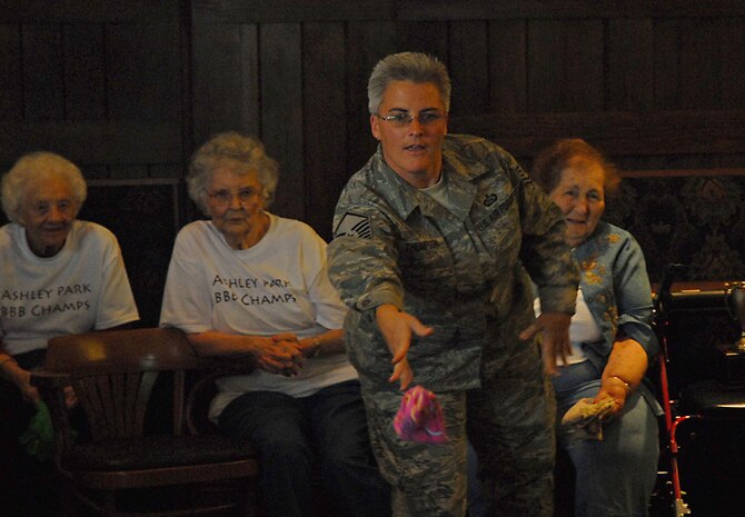 Master Sgt. Tammy Thompson takes a shot at beanbag baseball in the Charleston Club Oct. 3. The 437th Operations Support Squadron meets quarterly with members from the Ashley Park Retirement Community for lunch and a game of beanbag baseball. Sergeant Thompson is with the 437 OSS. (U.S. Air Force photo/Airman 1st Class Melissa White)