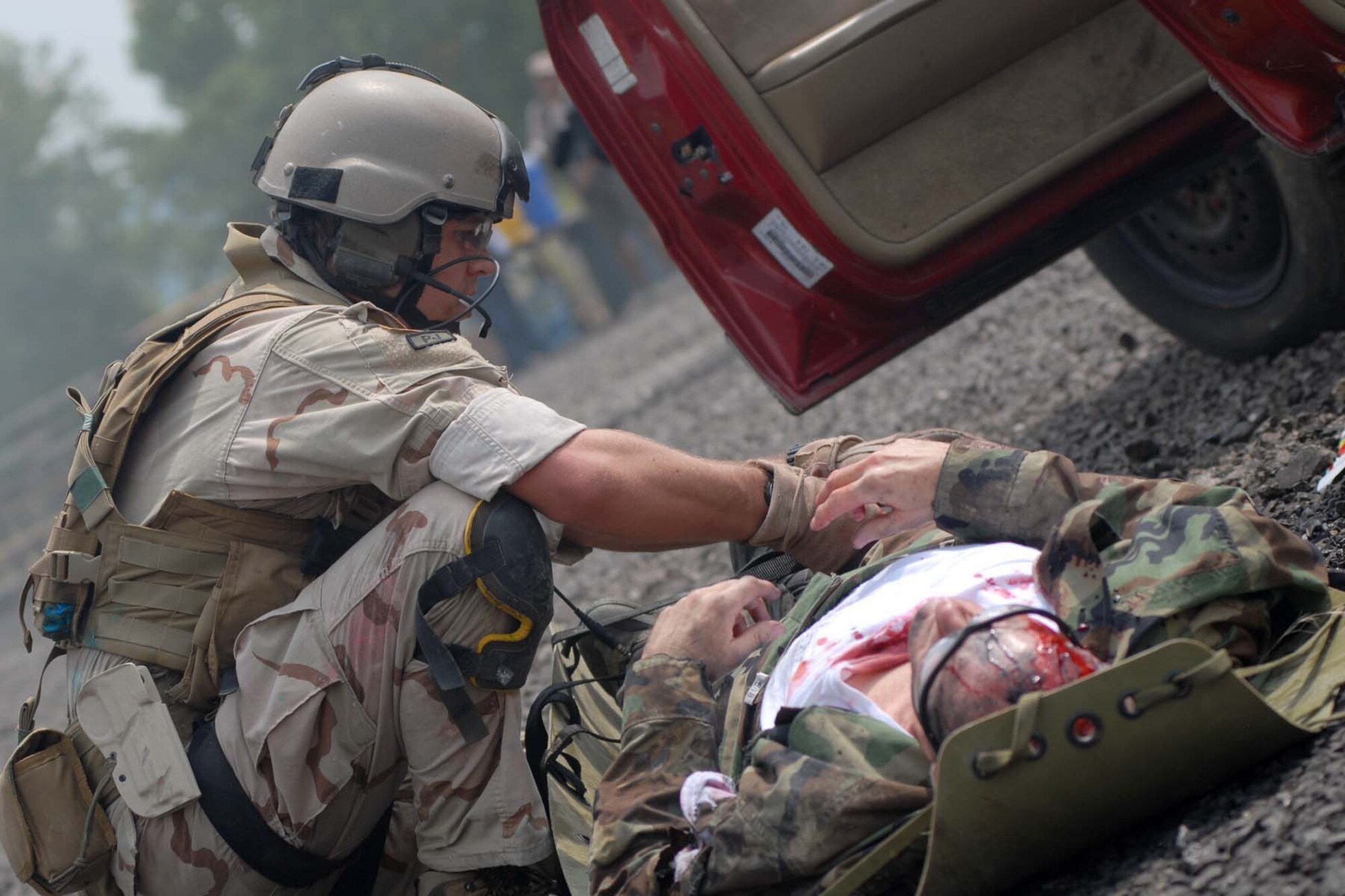 U.S. Air force photo of pararescuemen SRA Ryan Belew 0f the 123rd Special tactical Squadron preparing a patient for transporting  by litter during the Mass casualty exercise at the 2008 Para Rescue Rodeo hosted by the 123rd Special Tactics Squadron Kentucky Air National Guard. The rodeo consisted of Air Force, Air Force Reserve, Air National Guard and Canadian participants. During the weeklong event consisting of eight different teams they competed in five different areas. Mass casualty, Urban Tactical Personal Recovery, Confine Space, Rescue Jump Master, and the Canopy Accuracy event. The Main goal of the rodeo was competition, providing cross intelligence sharing and training in a simulated real life environment. (USAF Photo by MSgt Gerold O. Gamble) (released)
