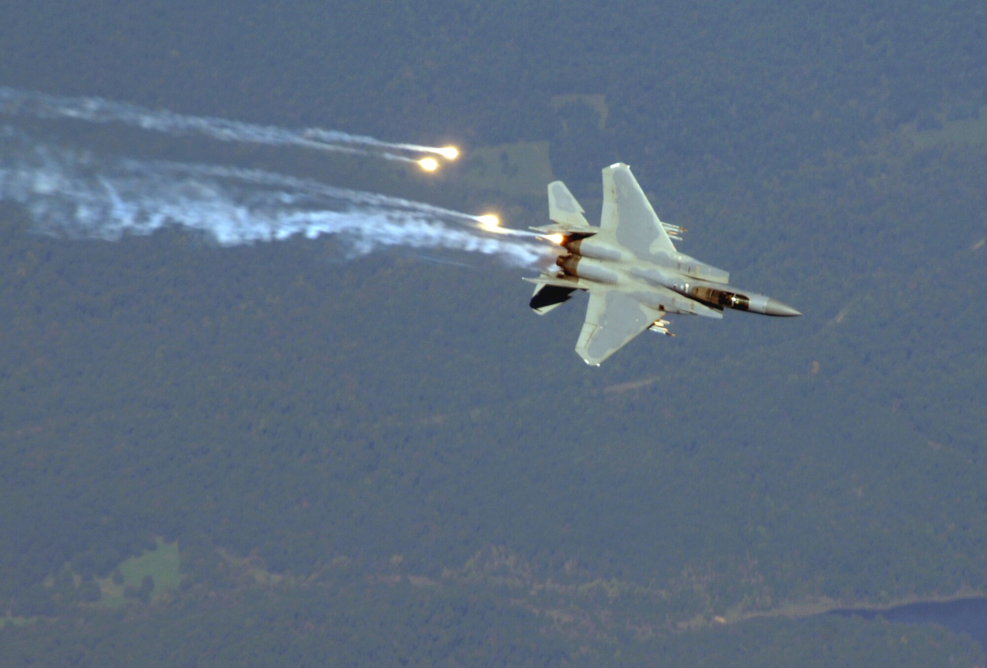 Lt. Col. John "Stick" Abell, 110th Fighter Squadron pilot, shoots flares from his F-15 Eagle Sept. 25.  Colonel Abell was taking part in an Aerial Combat Maneuver over Missouri. (Photo by Capt. Timothy Reinhart)