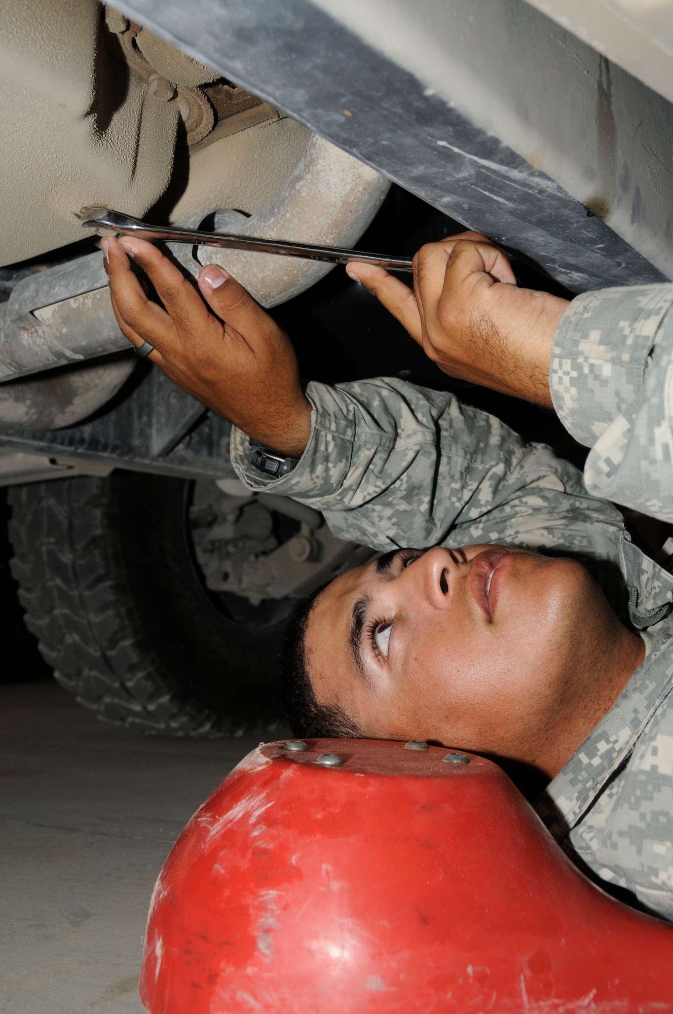 Spc. Brian Alvarado, vehicle operator assigned to Alpha 243, tightens up a starter on a High Mobility Multi-Wheeled Vehicle Oct. 4, 2008.  Alpha 243 provides early warning and air defense support for personnel and resources at this undisclosed air base in Southwest Asia.  Specialist Alvarado, a native of Coamo, Puerto Rico, is deployed from Fort Bliss, Texas, in support of Operations Iraqi and Enduring Freedom and Joint Task Force-Horn of Africa. (U.S. Air Force photo by Staff Sgt. Darnell T. Cannady/Released)