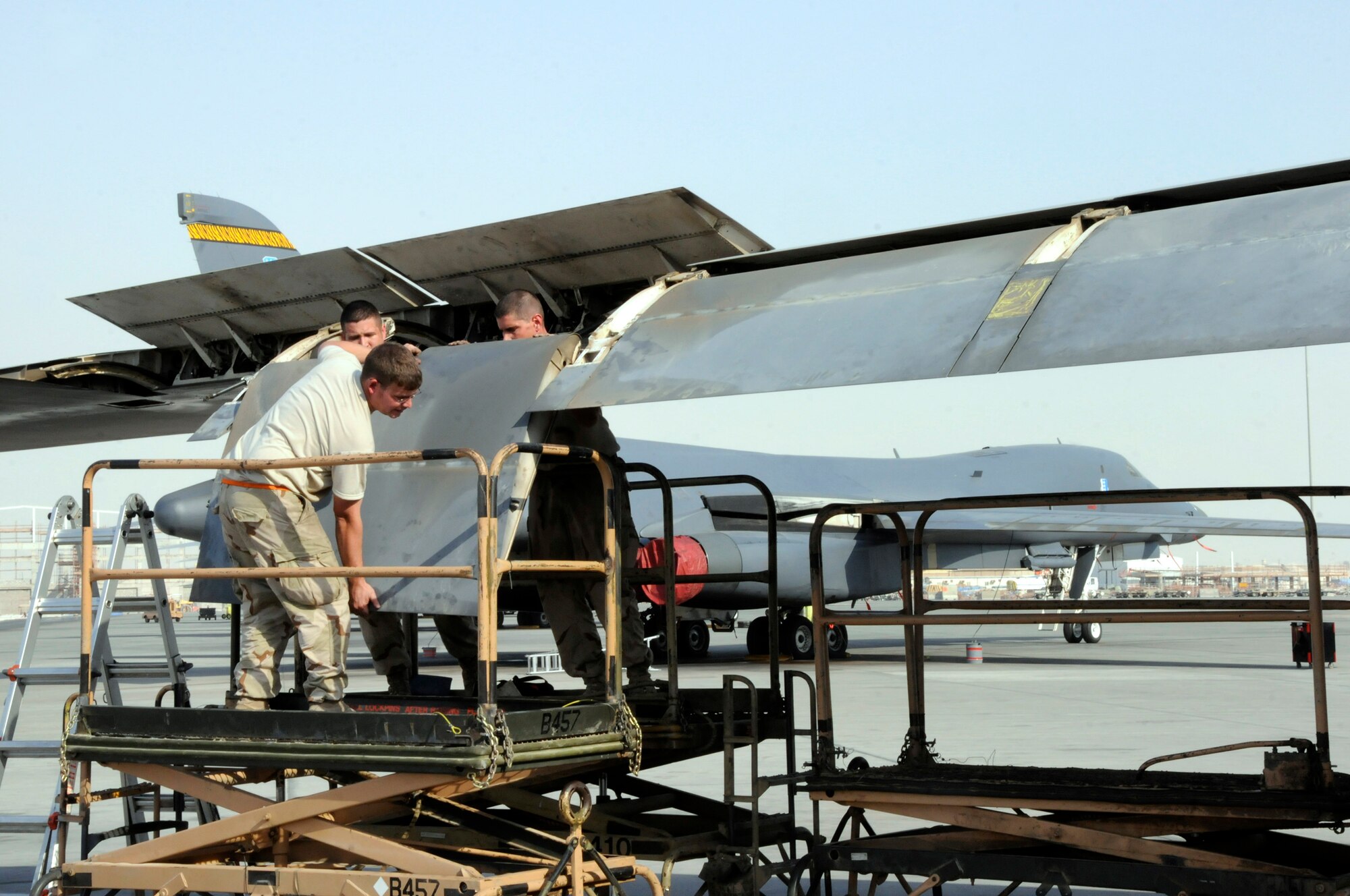 Tech. Sgt. Shaun Carroll, Airman 1st Class Gary Saari and Tech. Sgt. Donald Brogan, remove a flap from a B-1 Lancer October 5, 2008.  The crew, all assigned to the 379th Expeditionary Aircraft Maintenance Squadron, is pulling the flaps in order to trouble shoot a flap lock-up problem at an undisclosed air base in Southwest Asia.  The B-1 is often called upon to deliver precision weapons in support of ground troops engaged in Operations Iraqi and Enduring Freedom.  Sergeant Brogan, a native of Saint Charles, Mo., Sergeant Carroll, hailing from Charleston, S.C., and Airman Saari, originally from Las Vegas, Nev., are all deployed from Ellsworth Air Force Base, S.D.  (U.S. Air Force photo by Tech. Sgt. Michael Boquette/Released)