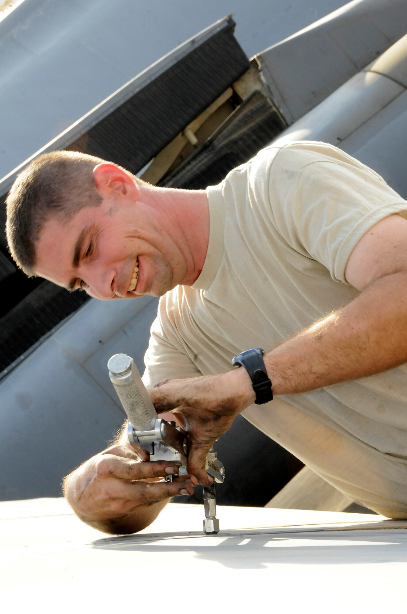 Tech. Sgt. Donald Brogan, 379th Expeditionary Aircraft Maintenance Squadron, 34th Aircraft Maintenance Unit, tightens a screw into a special wrench that is used for extra torque to remove screws from a B-1 Lancer flap October 5, 2008.  A maintenance crew is pulling the flaps from the B-1 Lancer in order to troubleshoot a flap lock-up problem at an undisclosed air base in Southwest Asia.  The B-1 is often called upon to deliver precision weapons in support of ground troops engaged in Operations Iraqi and Enduring Freedom.  Sergeant Brogan, a native of Saint Charles, Mo., is deployed from Ellsworth Air Force Base, S.D.  (U.S. Air Force photo by Tech. Sgt. Michael Boquette/Released)