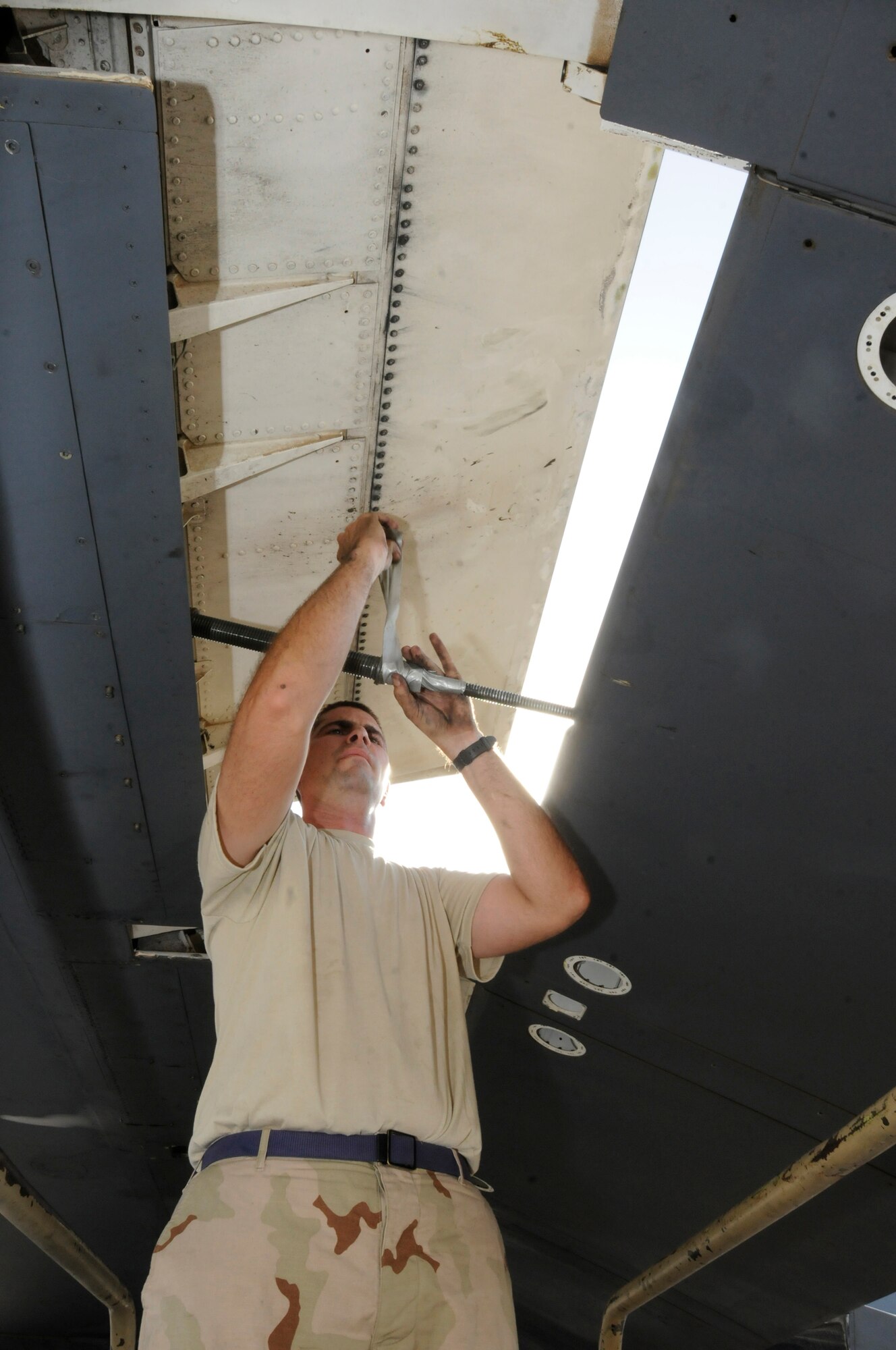 Tech. Sgt. Donald Brogan, 379th Expeditionary Aircraft Maintenance Squadron, 34th Aircraft Maintenance Unit, tapes the flap actuator to hold its position and prevent having to rerig the actuator October 5, 2008.  A maintenance crew is pulling the flaps from the B-1 Lancer in order to troubleshoot a flap lock-up problem at an undisclosed air base in Southwest Asia.  The B-1 is often called upon to deliver precision weapons in support of ground troops engaged in Operations Iraqi and Enduring Freedom.  Sergeant Brogan, a native of Saint Charles, Mo., is deployed from Ellsworth Air Force Base, S.D.  (U.S. Air Force photo by Tech. Sgt. Michael Boquette/Released)