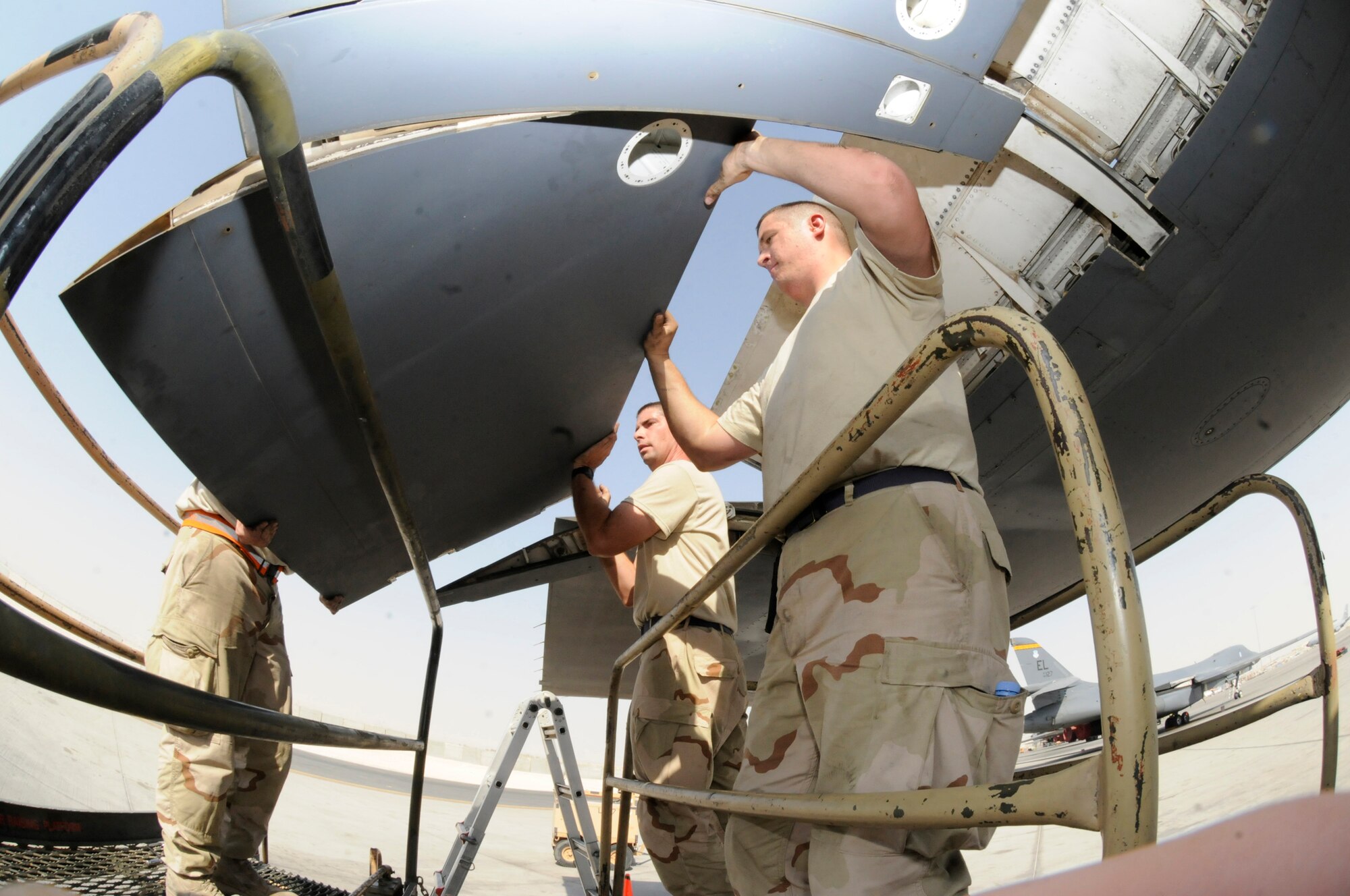 Tech. Sgt. Shaun Carroll and Airman 1st Class Gary Saari assist Tech. Sgt. Donald Brogan in removing a B-1 Lancer flap from the flap carriage October 5, 2008.  The crew, all assigned to the 379th Expeditionary Aircraft Maintenance Squadron, is pulling the flaps in order to trouble shoot a flap lock-up problem at an undisclosed air base in Southwest Asia.  The B-1 is often called upon to deliver precision weapons in support of ground troops engaged in Operations Iraqi and Enduring Freedom.  Sergeant Brogan, a native of Saint Charles, Mo., Sergeant Carroll, hailing from Charleston, S.C., and Airman Saari, originally from Las Vegas, Nev., are all deployed from Ellsworth Air Force Base, S.D.  (U.S. Air Force photo by Tech. Sgt. Michael Boquette/Released)