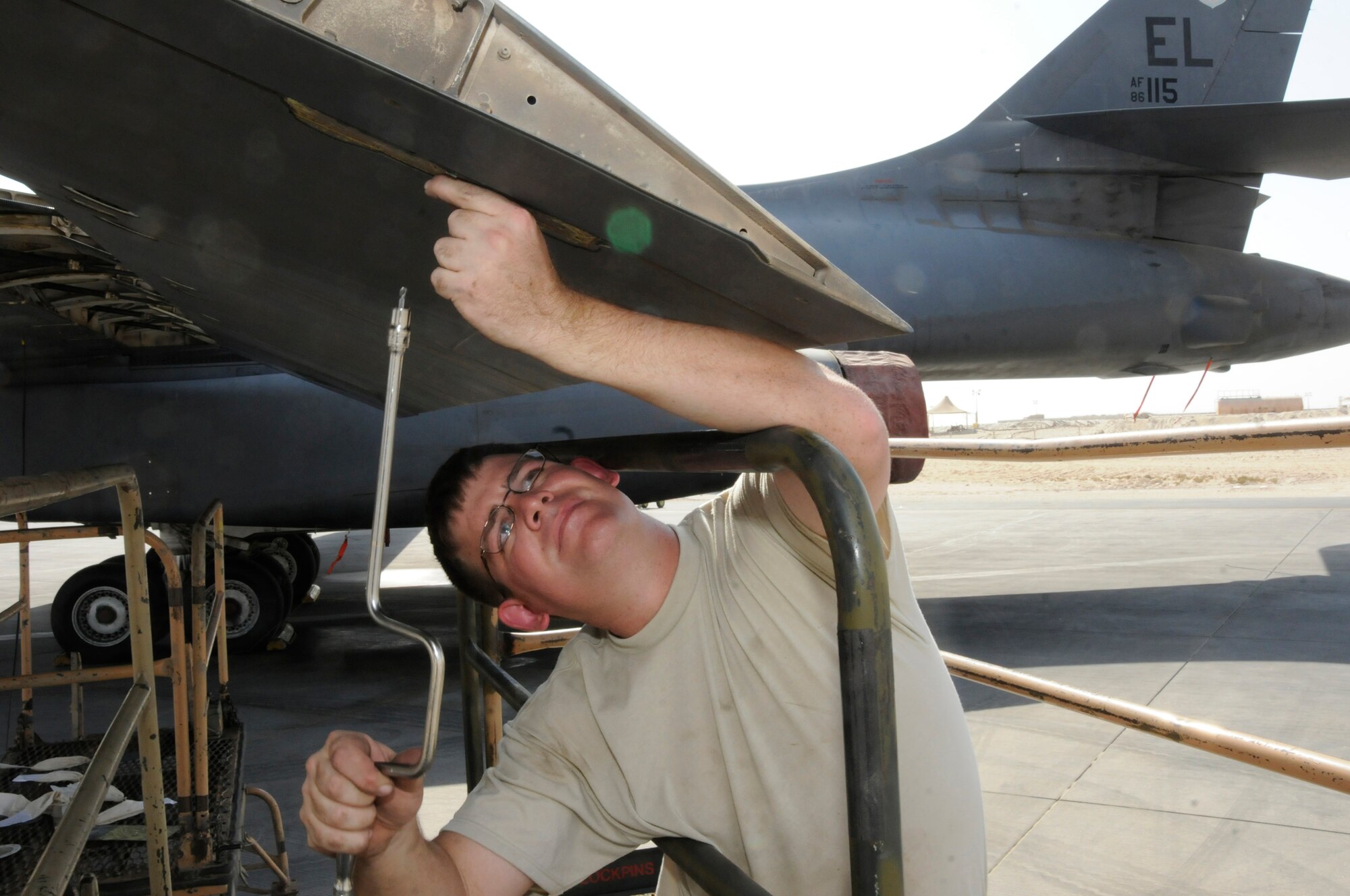 Tech. Sgt. Shaun Carroll, 379th Expeditionary Aircraft Maintenance Squadron, removes the bolts holding a flap to flap carriage Oct. 5, 2008.  The crew is pulling the flaps from the B-1 Lancer in order to trouble shoot a flap lock-up problem at an undisclosed air base in Southwest Asia.  The B-1 is often called upon to deliver precision weapons in support of ground troops engaged in Operations Iraqi and Enduring Freedom.  Sergeant Carroll, a native of Charleston, S.C., is deployed from Ellsworth Air Force Base, S.D.  (U.S. Air Force photo by Tech. Sgt. Michael Boquette/Released)