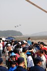 KUSAN AIR BASE, Republic Of Korea -- Spectators scramble for a better view during the 2008 Gunsan Airshow here, Oct. 5. More 250,000 people were attracted to the two-day event held in the city of Gunsan, Oct. 4-5. (U.S. Air Force photo/Staff Sgt. Jason Colbert)