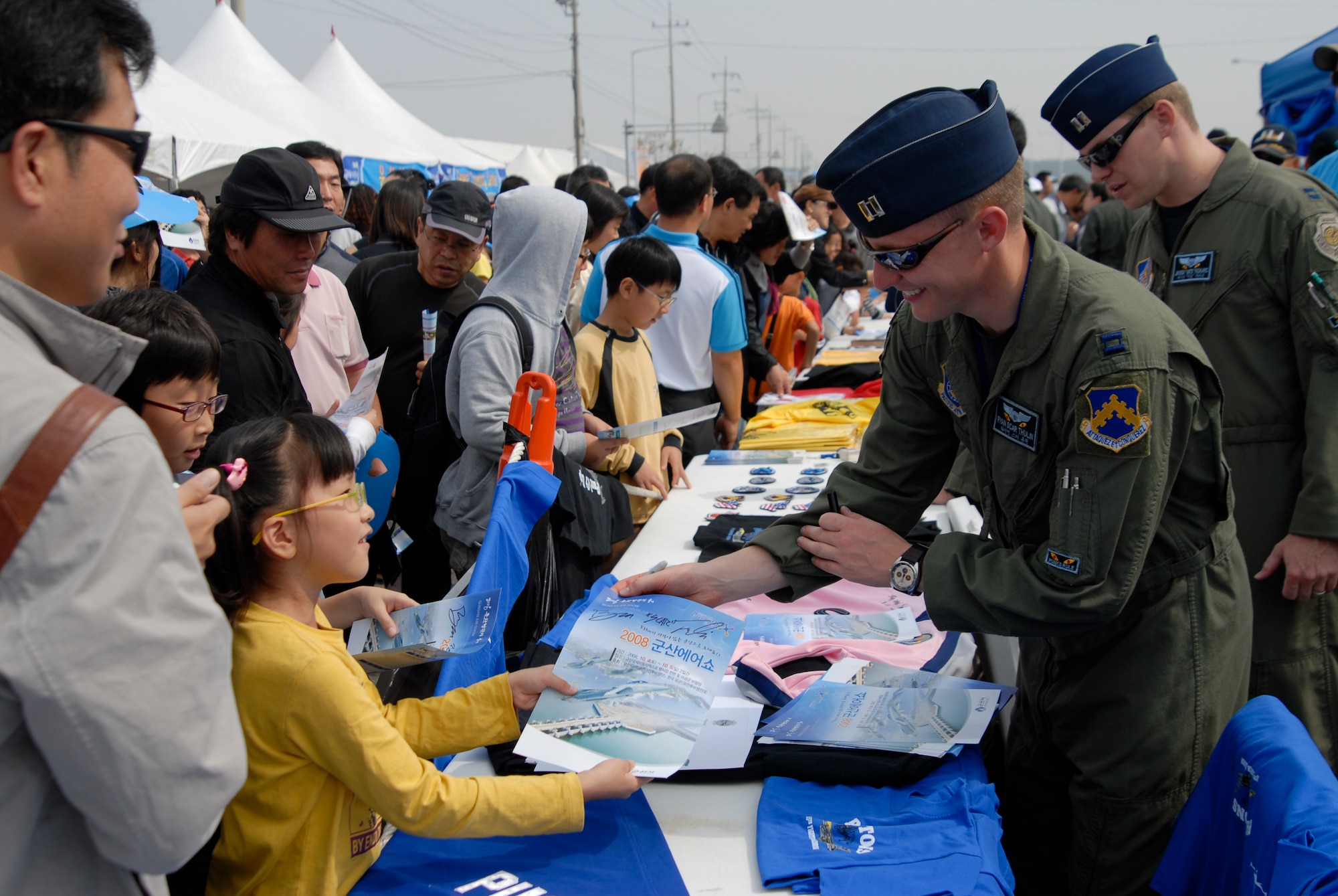 KUSAN AIR BASE, Republic Of Korea -- U.S. Air Force Capt. Ryan "Scar" Thulin, 35th Fighter Squadron, signs an autograph for a lttle girl during the 2008 Gunsan Airshow, Oct. 5.  More than 250,000 people were attracted to the two day event held in the city of Gunsan, Oct. 4-5. (U.S. Air Force photo/Staff Sgt. Jason Colbert) 