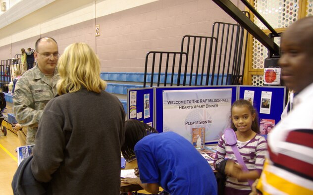 Attendees sign in at the Hearts Apart Dinner held at the RAF Mildenhall Youth Program Center Sept. 25, 2008. Air Commando volunteers provided and manned a buffet-style dining experience to valued Team Mildenhall spouses during the event. (U.S. Air Force photo by Master Sgt. Dennis Brewer)  