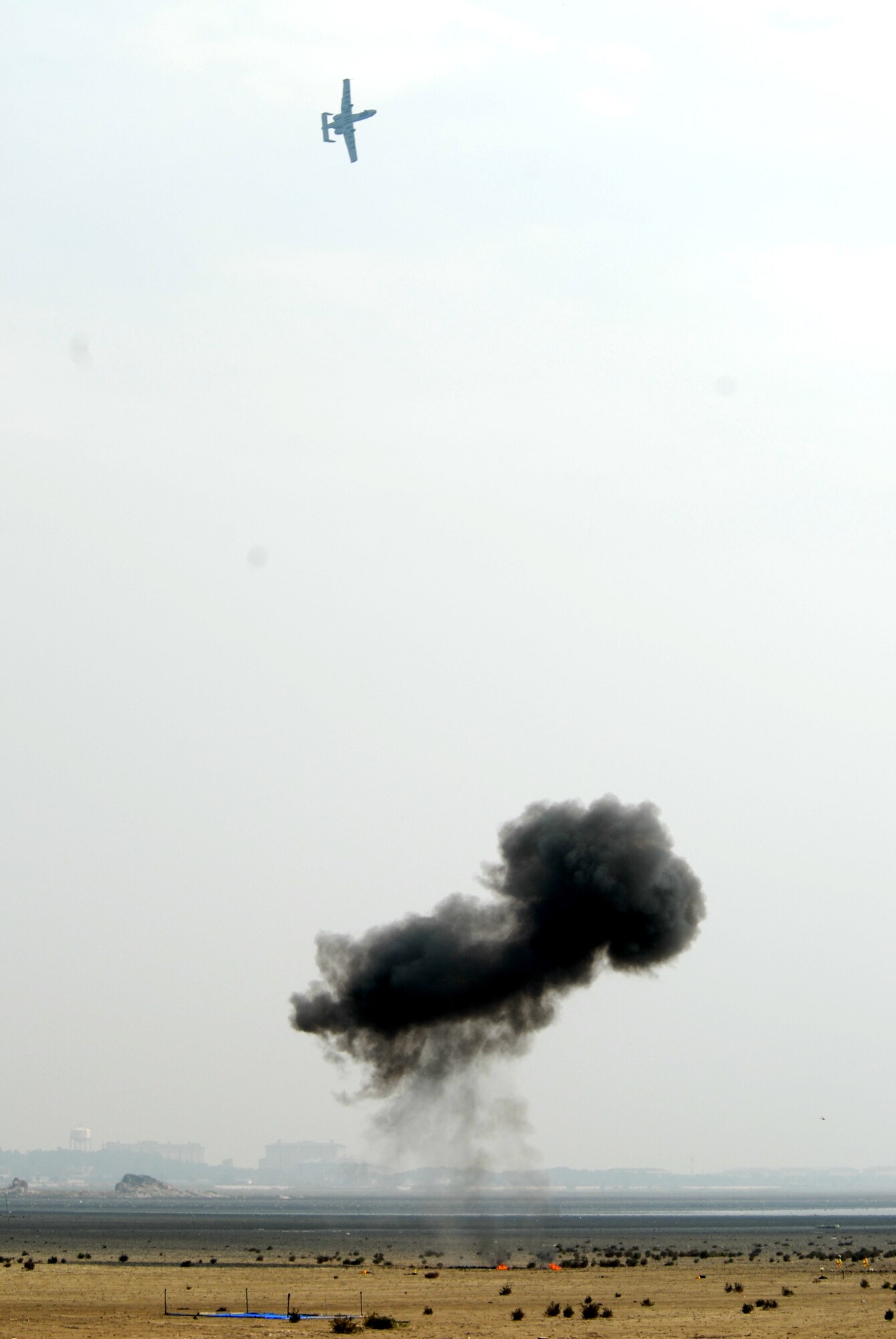 KUNSAN AIR BASE, Republic Of Korea -- An A-10 from Davis-Monthan Air Force Base, Ariz., flys over a simulated explosion during the Gunsan partnership Air show, Oct. 5. The City of Gunsan, 8th Fighter Wing and Republic of Korea Air Forces’ 38th Fighter Group hosted the first ever partnership Air Show, Oct. 4-5. (U.S. Air Force photo by: Senior Airman Angela Ruiz) 