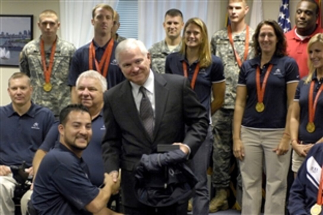 Defense Secretary Robert M. Gates receives a team jacket from one of the Paralympians visiting the Pentagon, Oct. 6, 2008. Military personnel representing both the Olympic and Paralympic teams met with Gates and received a guided tour of the Pentagon.
