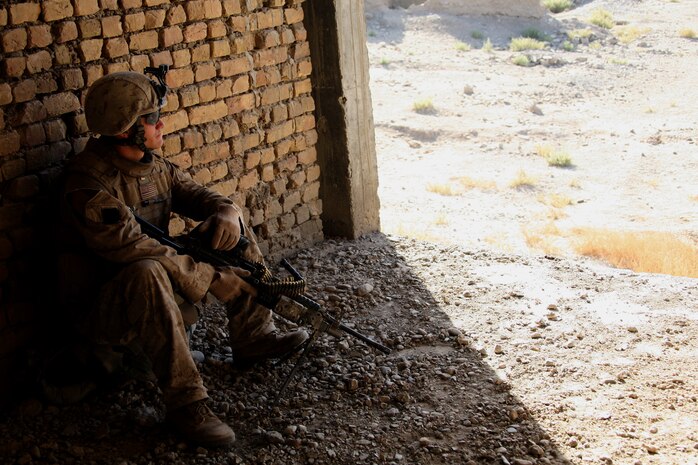 Lance Cpl. Michael N. McWilliams, a squad automatic weapon gunner assigned to Company E, TF 2/7, and Kansas City, Kan., native, keeps a vigilant eye for enemy movement near the Sangin District Center, Oct. 8.