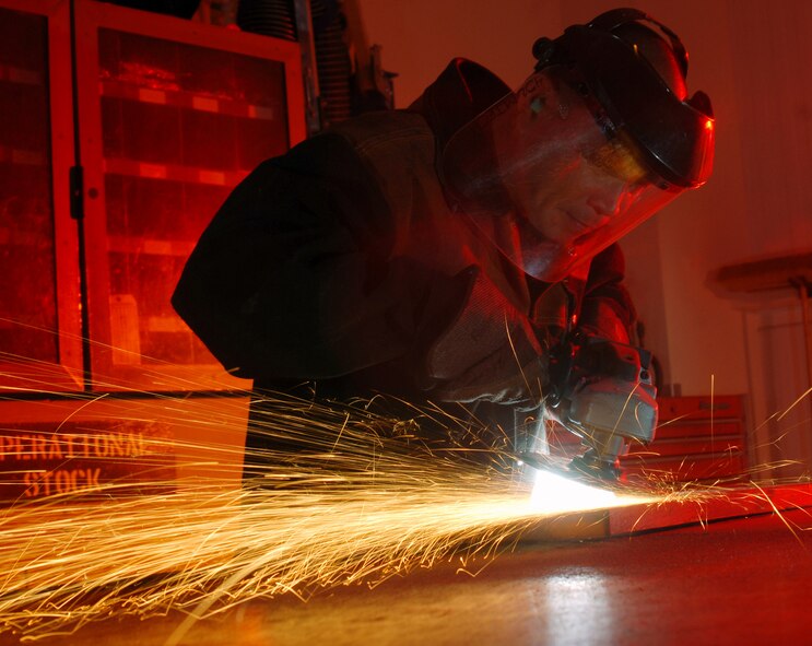 Technical Sgt. Percy Padilla, a metals technician at 452nd Maintenance Squadron, uses a grinder to shape a metal part. The tool is used for a number applications, like removing paint or grinding down a weld. As a metals technician, Padilla also machines metal parts. Metals technicians are part of the squadron’s Fabrication Flight and work out of the Metals Technology shop. (U.S. Air Force photo by Val Gempis)
